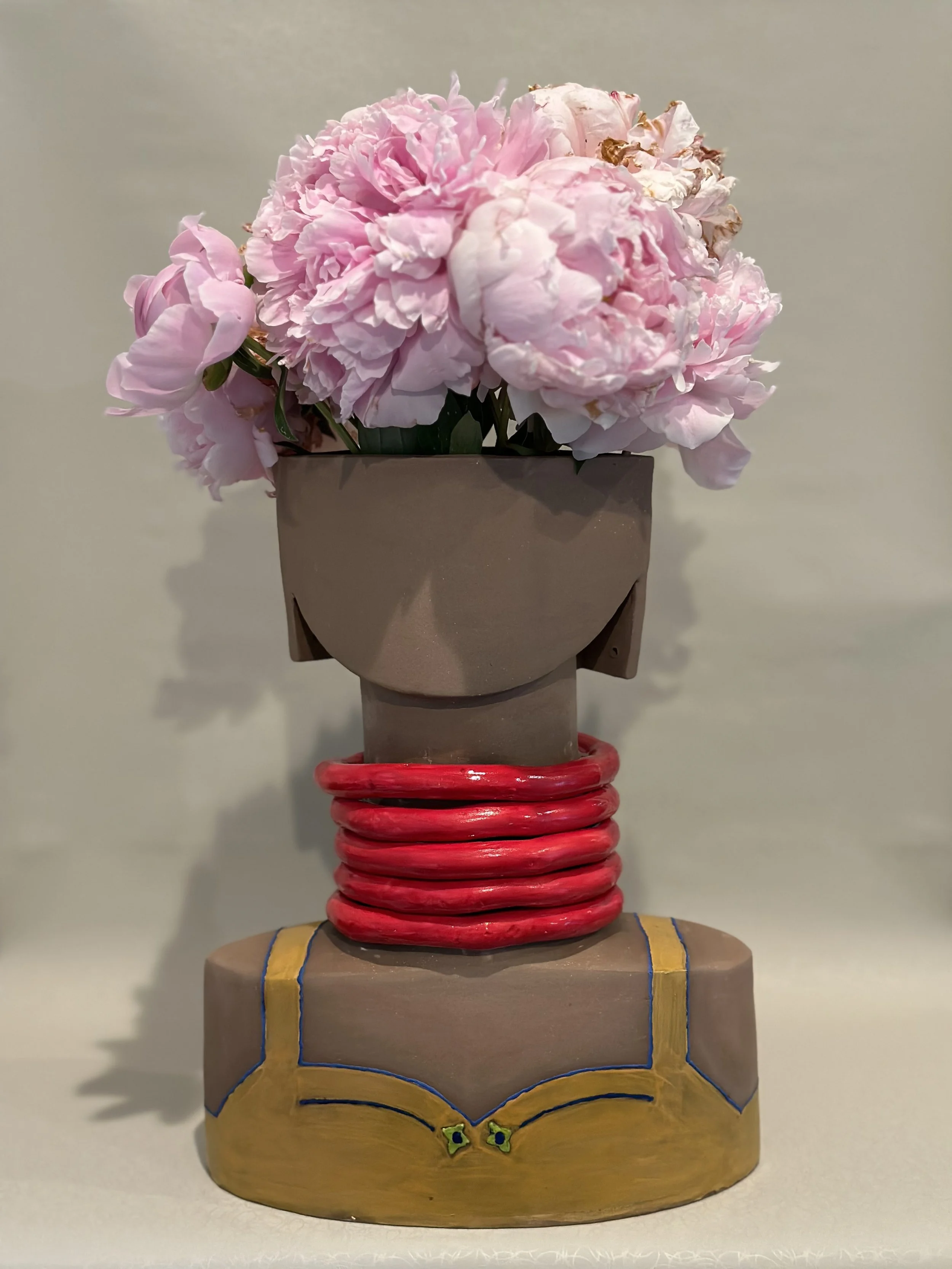 Menina-moça. 
She is growing up. 
Not a girl, not a woman (yet). 
She is menina-moça. 
Her head is full of dreams. 
She dresses with the colors of some of her dreams. 
Will they ever come true?