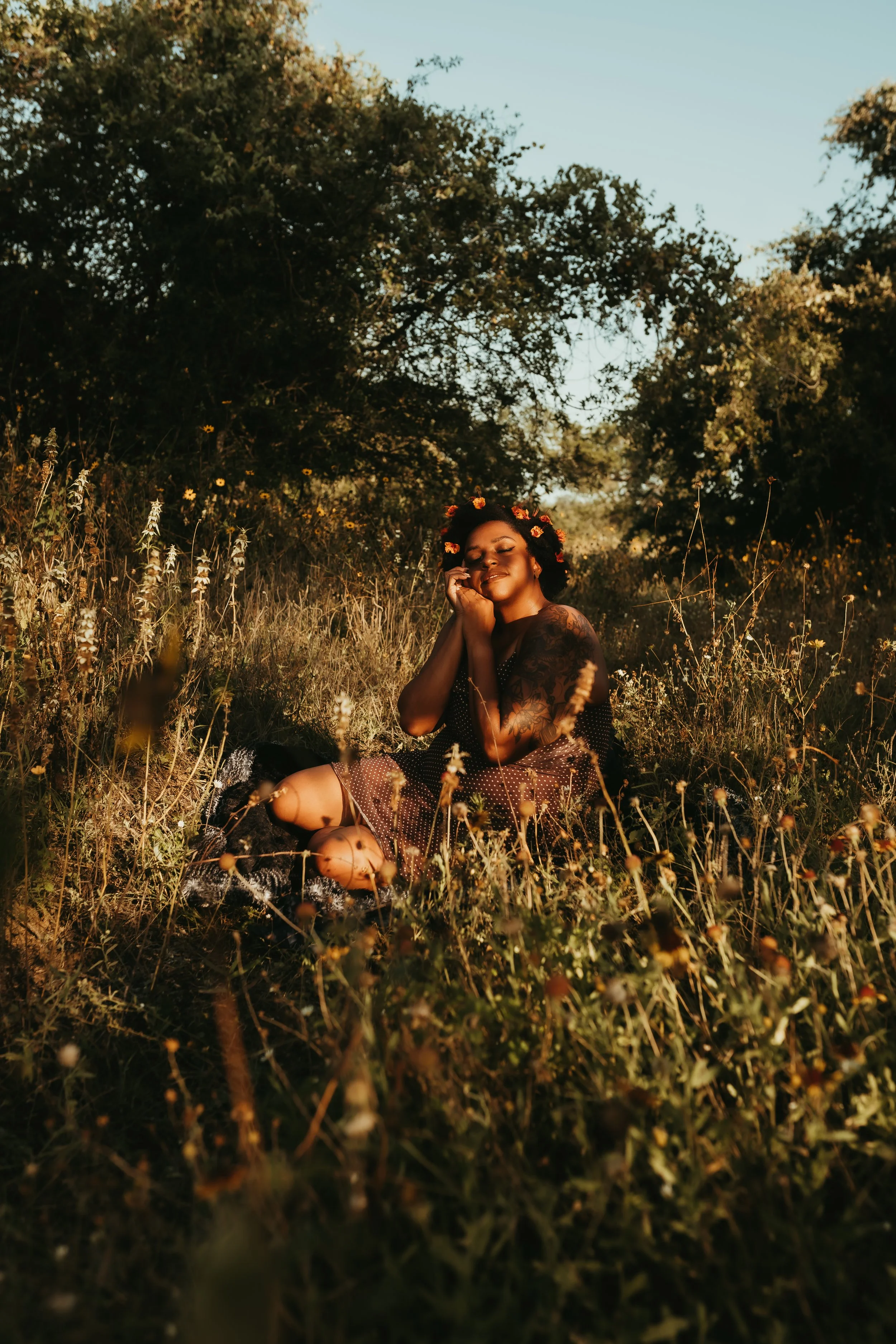 a black woman in a field of flowers.jpg