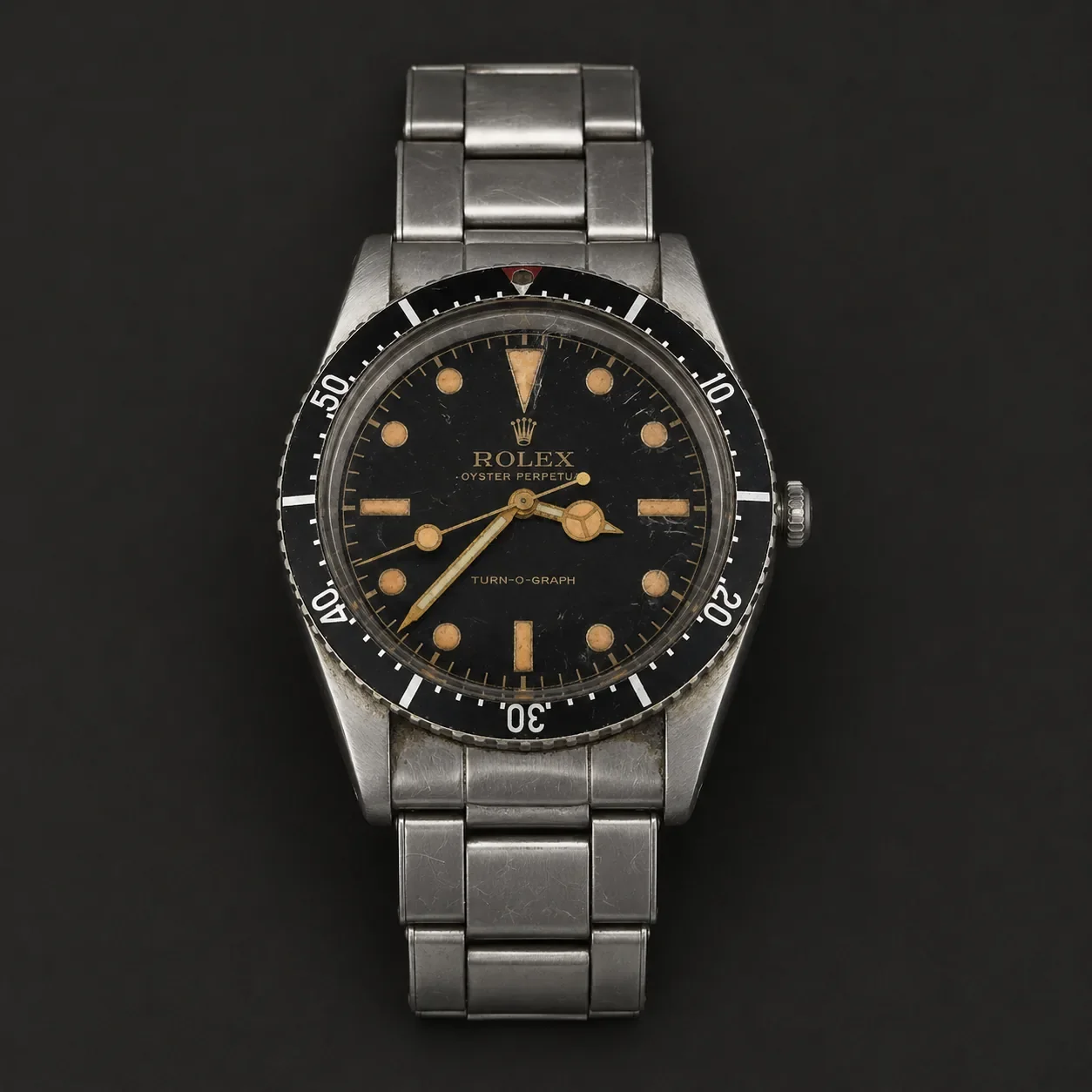 Vintage Rolex Turn-O-Graph reference 6202 wristwatch with original black dial and stainless steel Oyster bracelet.