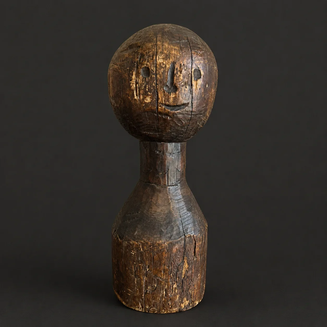 An early 19th century hand carved wooden folk art sculpture with rich patina, known as a bedpost doll.