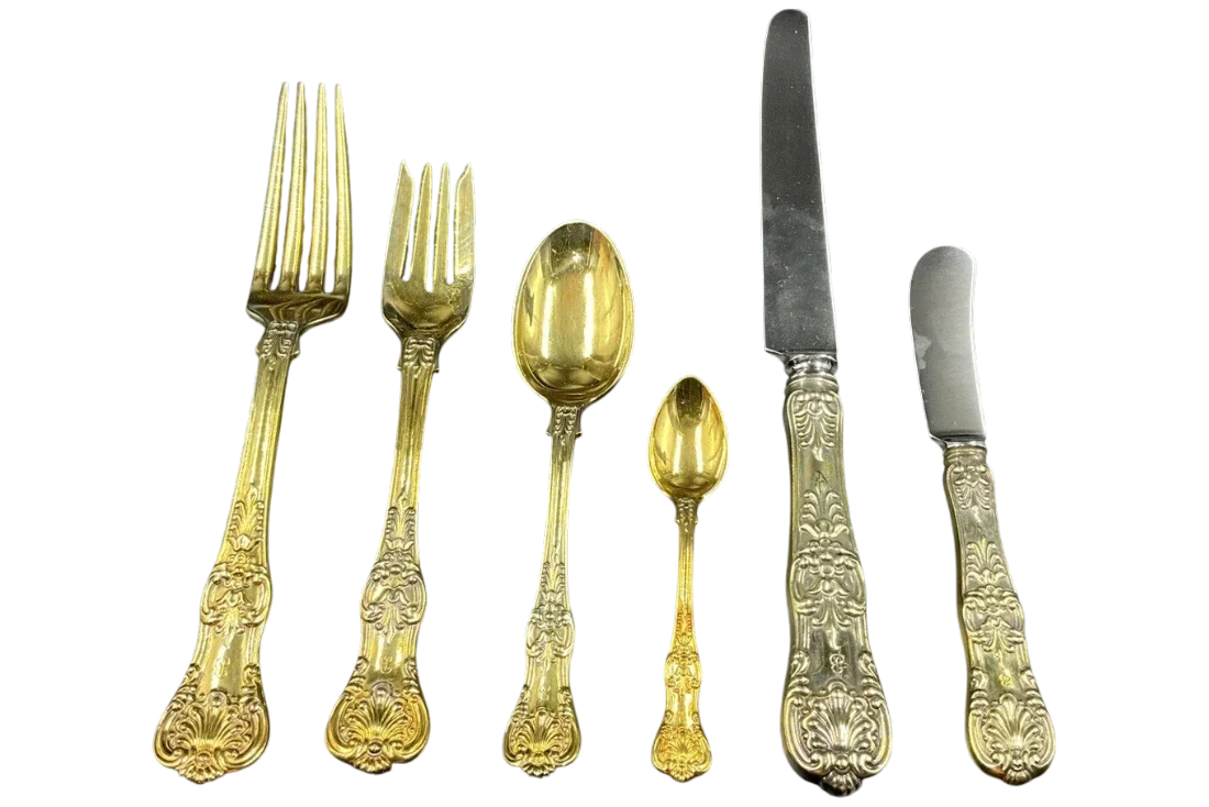 Tiffany & Co. sterling silver English King pattern flatware set with gold-washed serving pieces including forks, spoons, and knives.