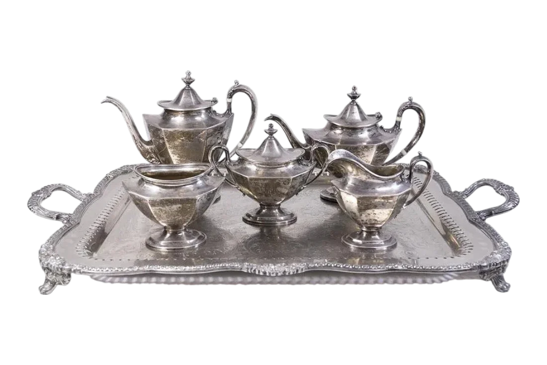 Antique sterling silver tea service with matching tray, teapot, coffee pot, creamer, and sugar bowl.