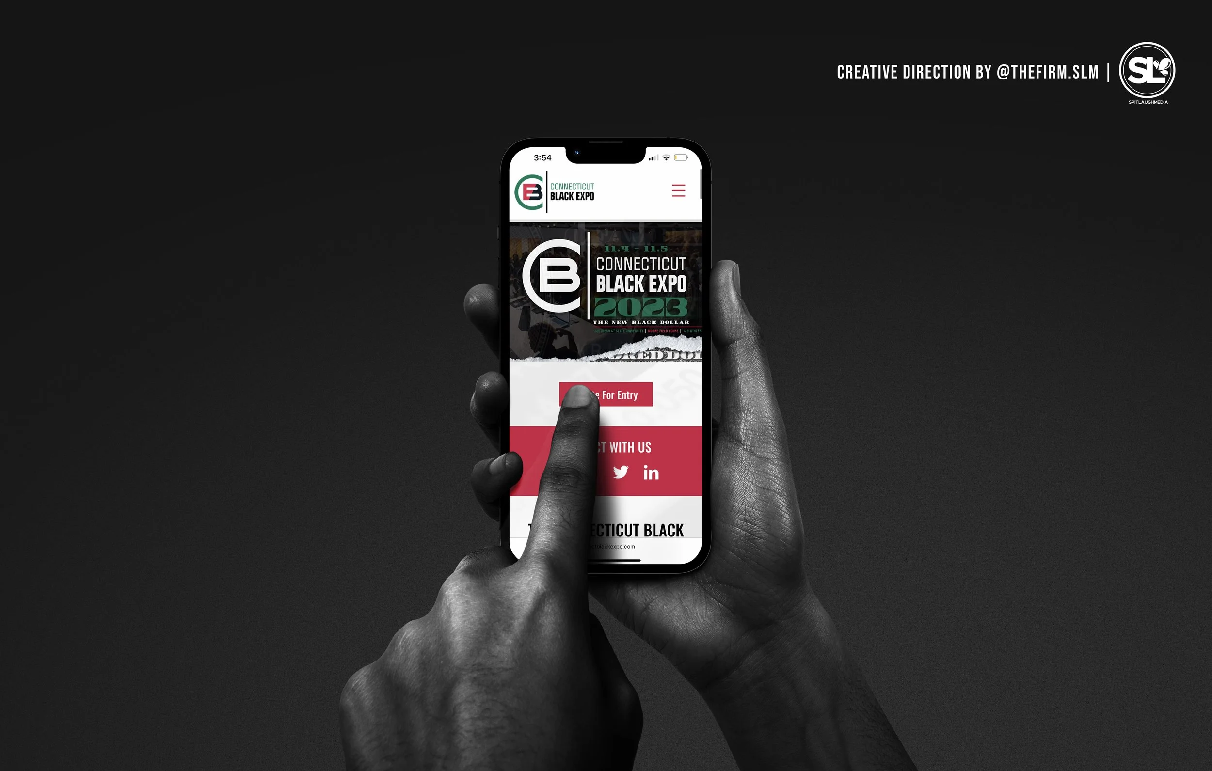 A black and white photo of a hand holding a smartphone displaying a website for the Connecticut Black Expo, with a red button and social media icons at the bottom.