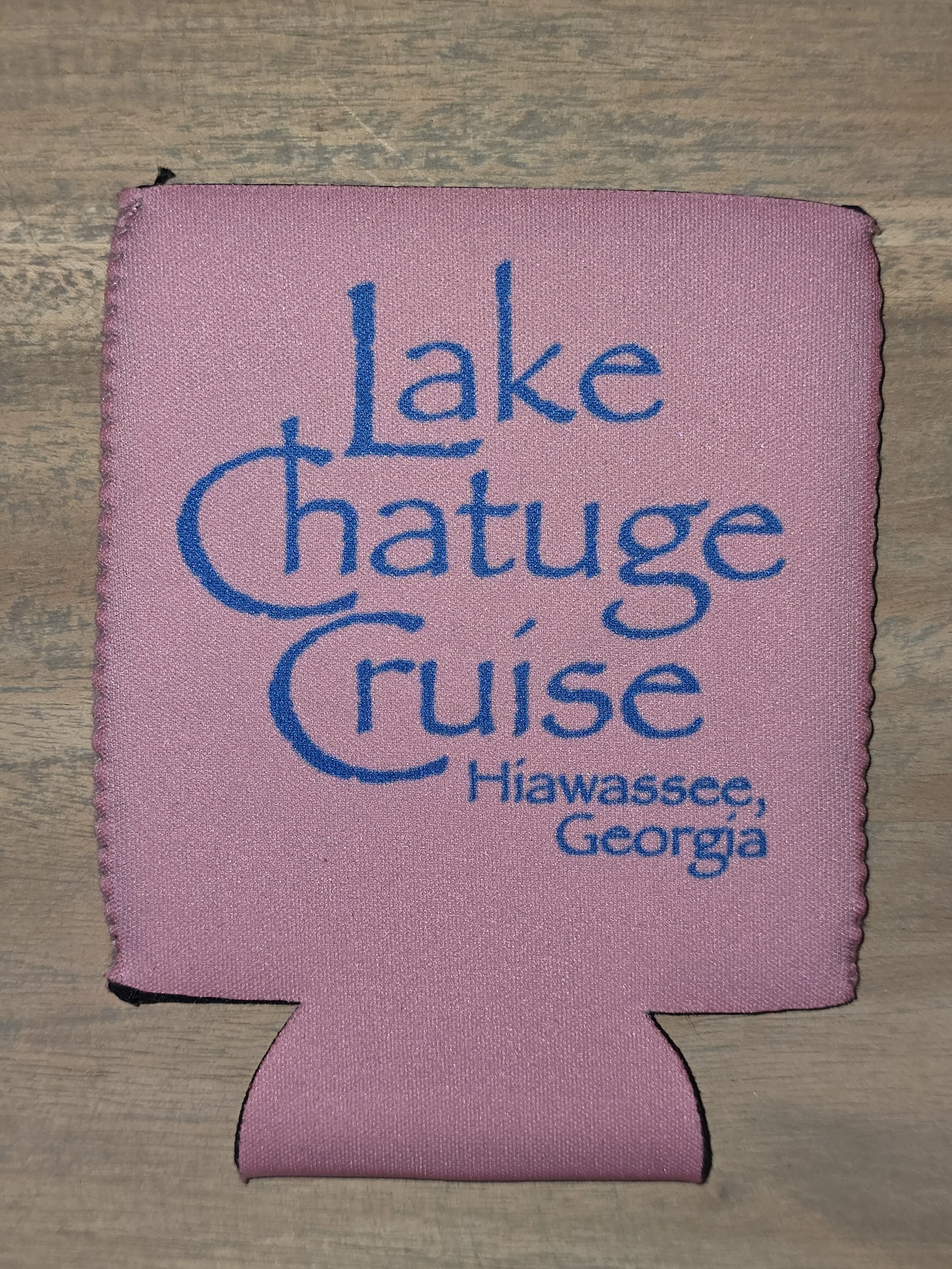 Pink fabric band with blue text that reads 'lake Chatuga cruise Hiawassee, Georgia'.