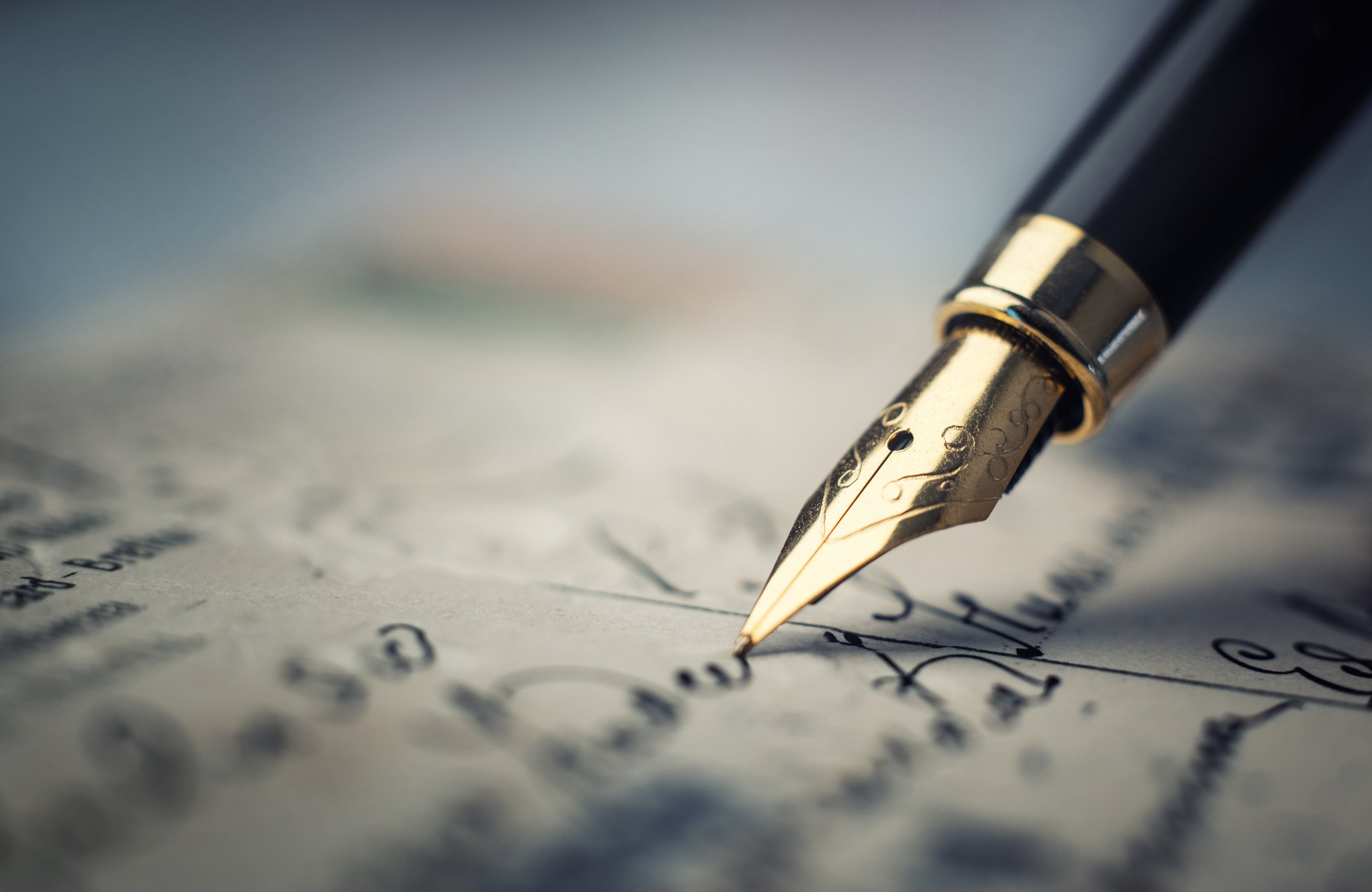 Close-up of a fountain pen writing on paper
