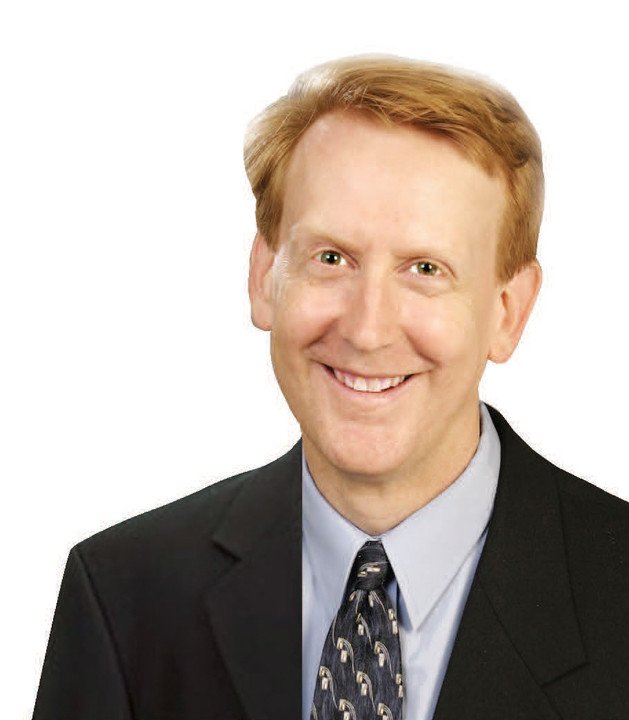 Smiling man in formal attire against white background