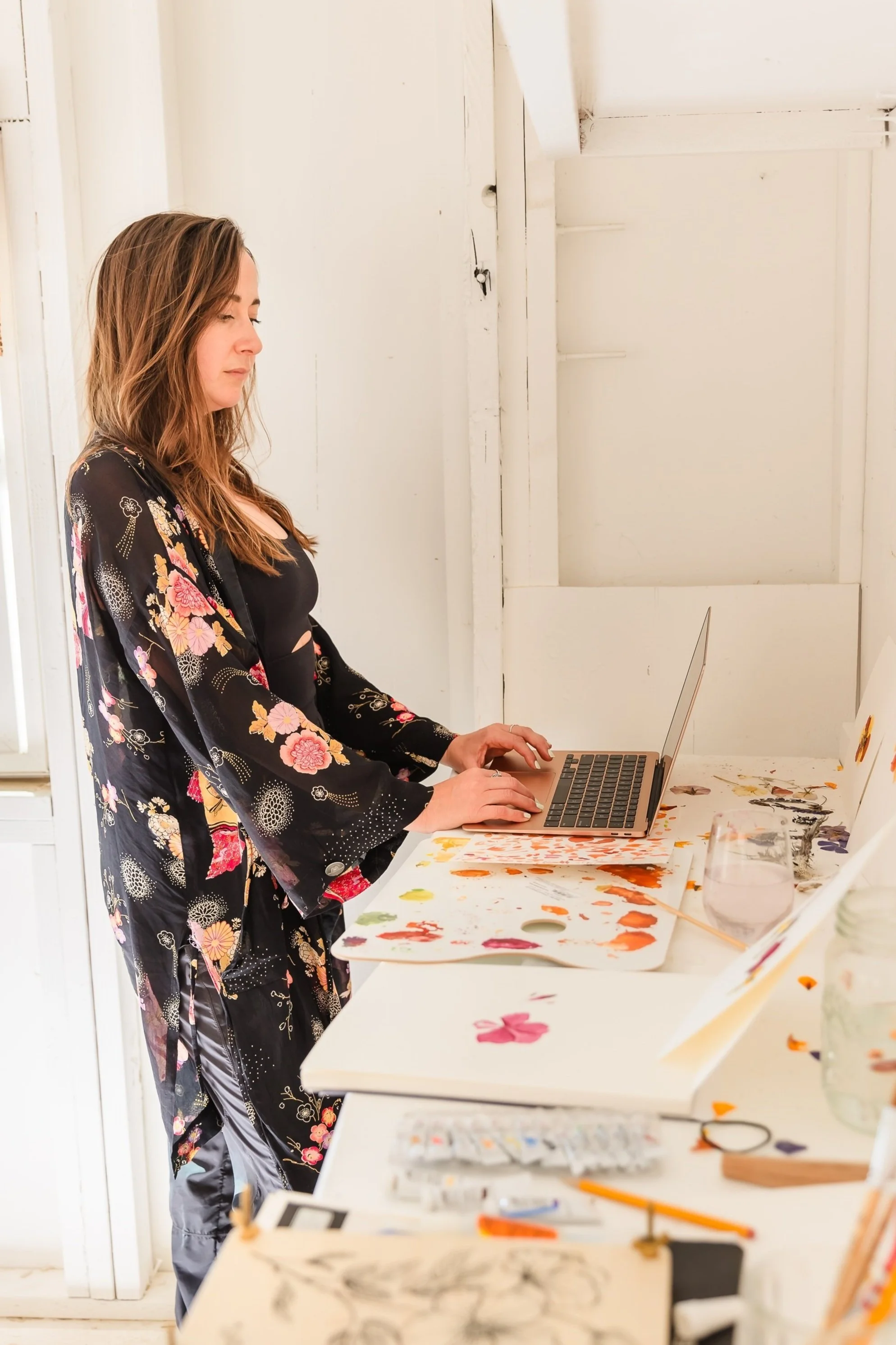 Caroline Mauro, founder of REWOLF creative, a Colorado brand strategist and creative storyteller, working from her client's art studio.