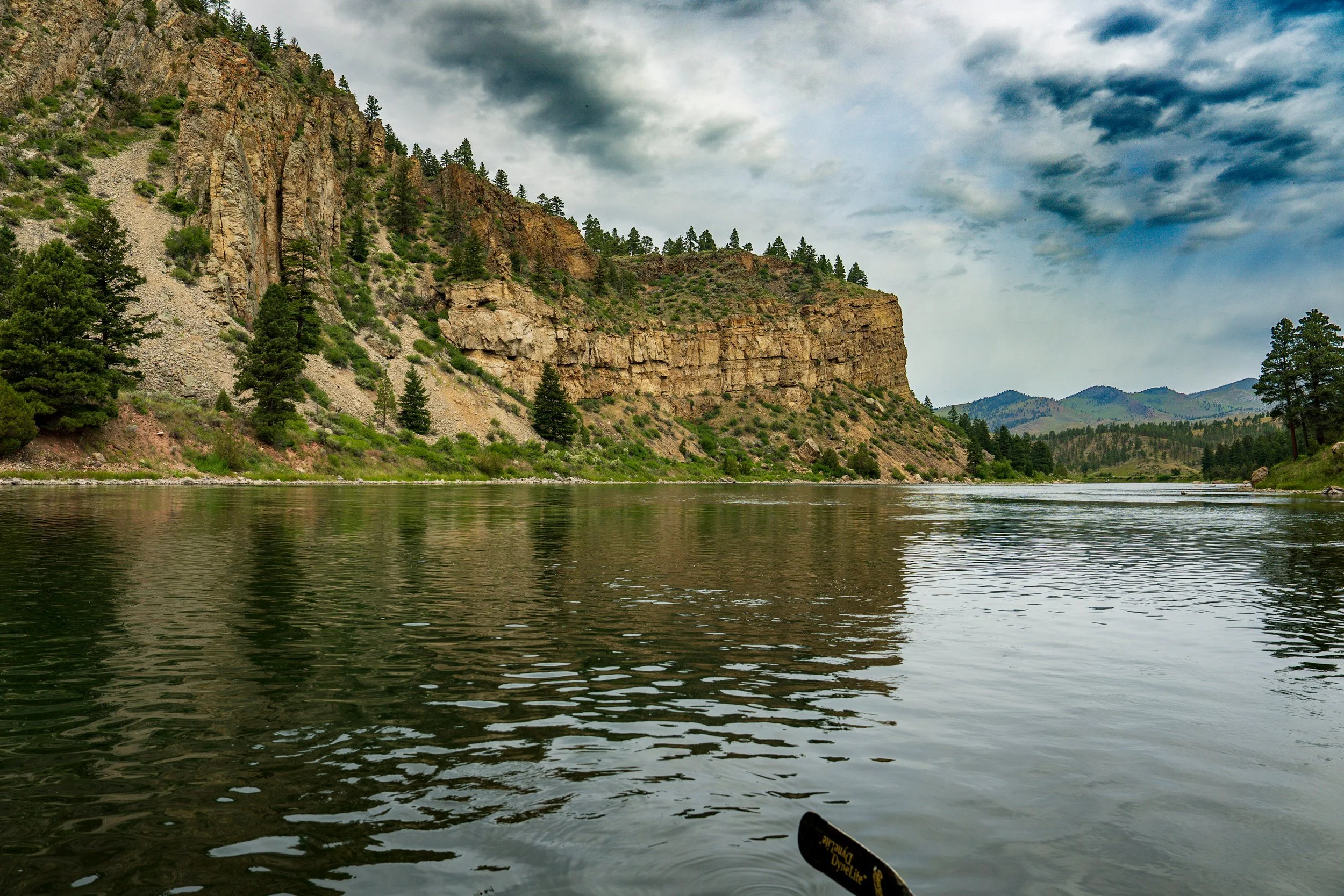 Sandstone bluff reflected in the river, Montana
