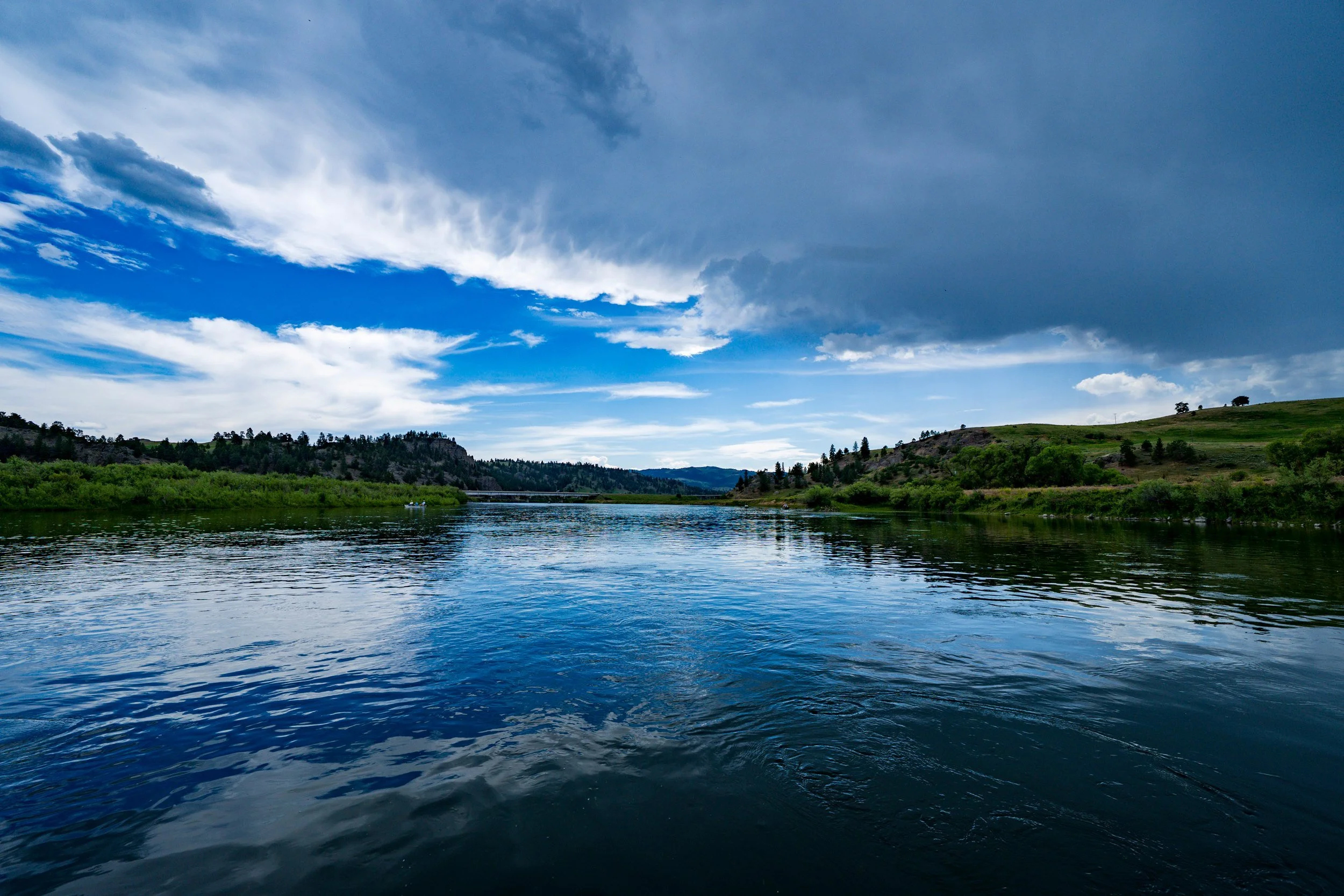 Blue river under rolling clouds, Montana