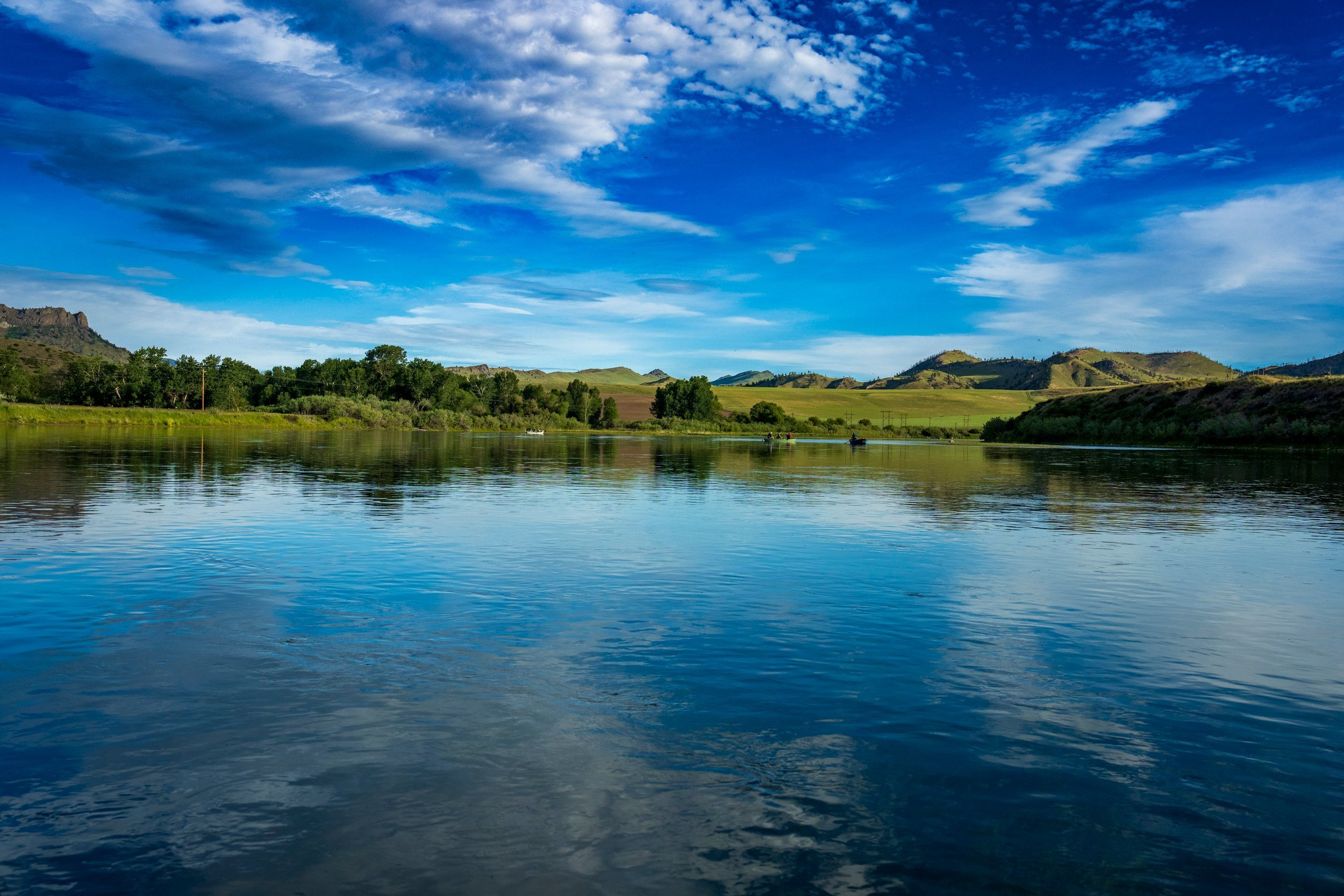 Deep blue river under white clouds, Montana