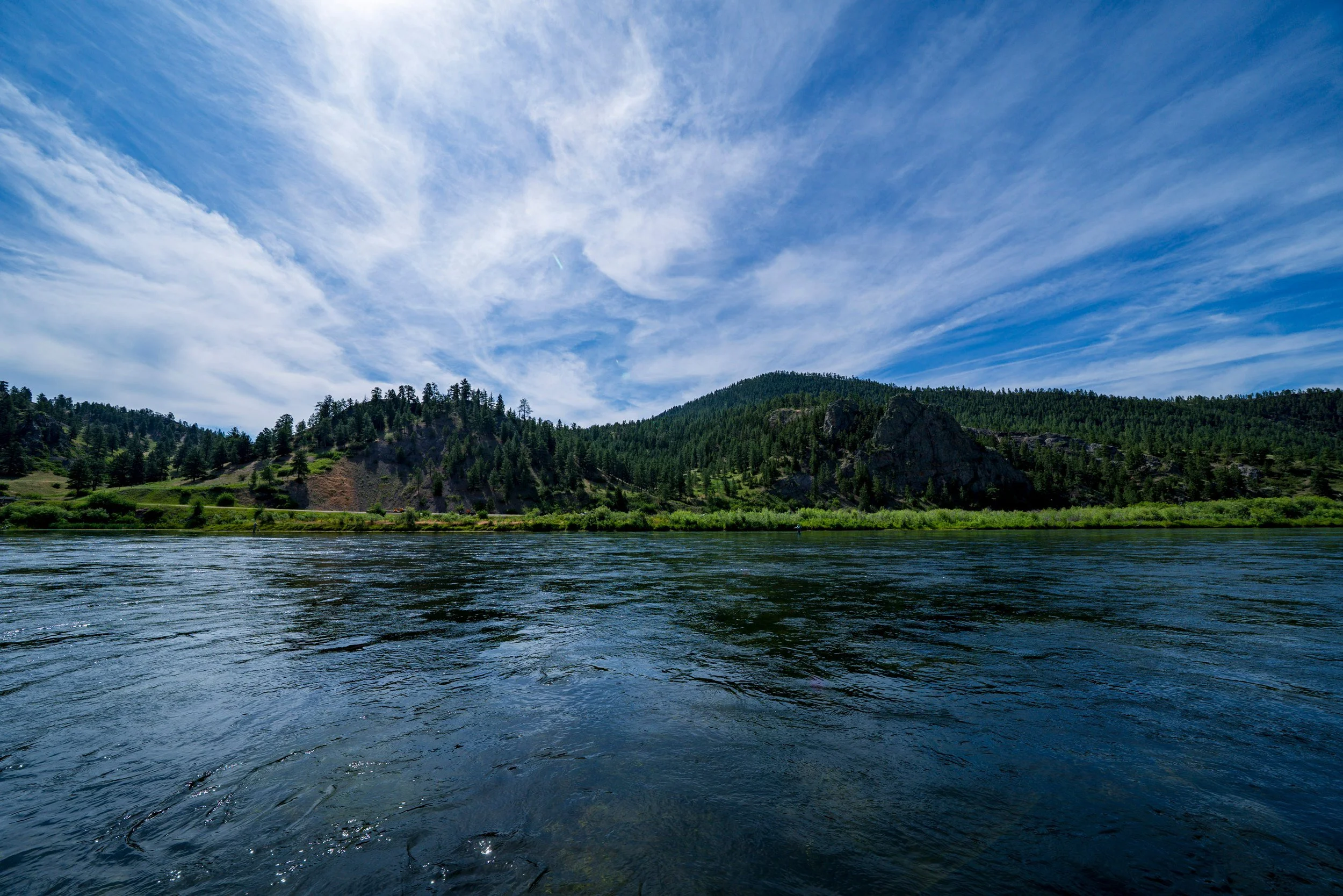 Wispy clouds over a blue river, Montana