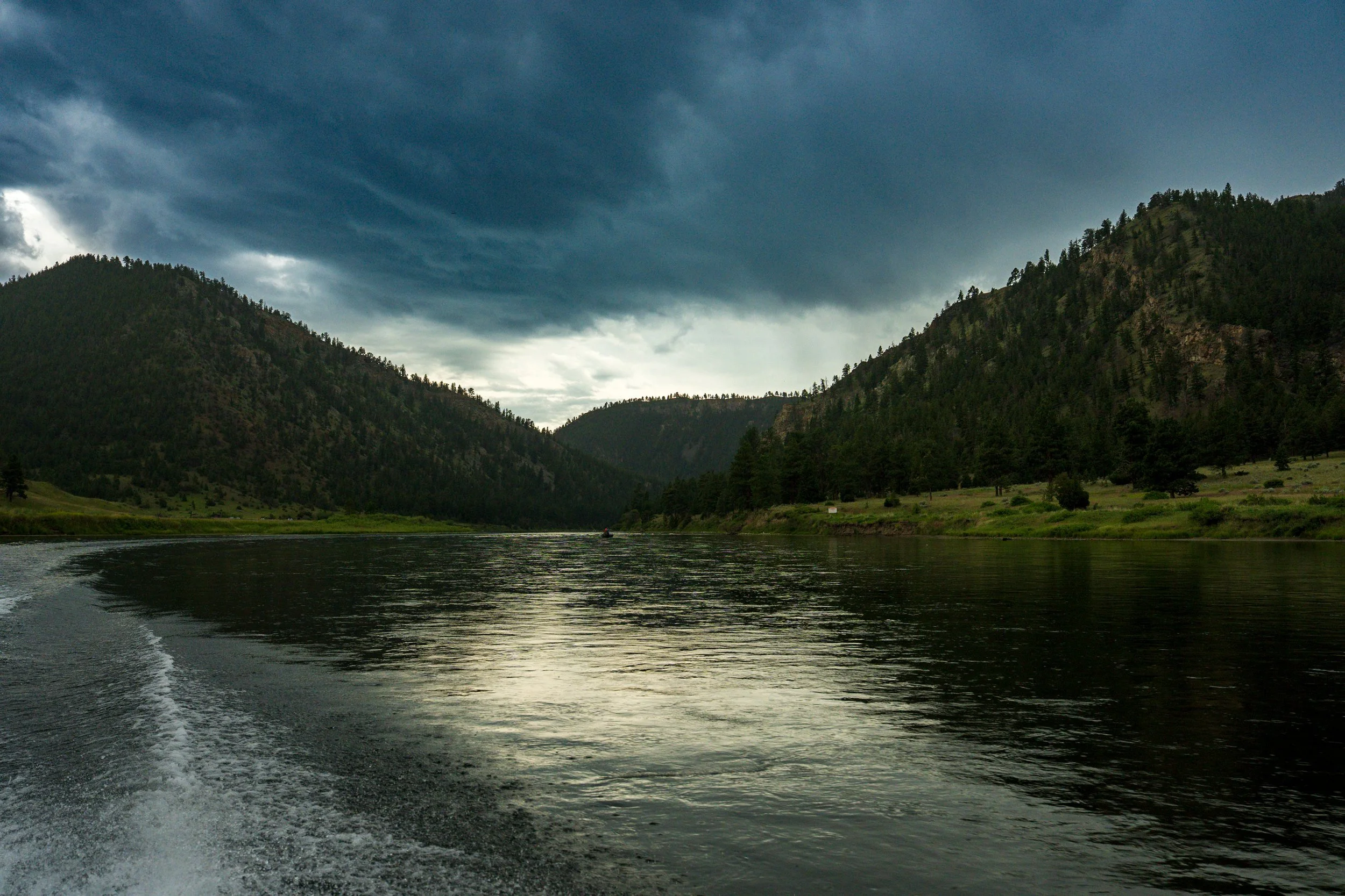 Clouds reflected on a dark river, Montana