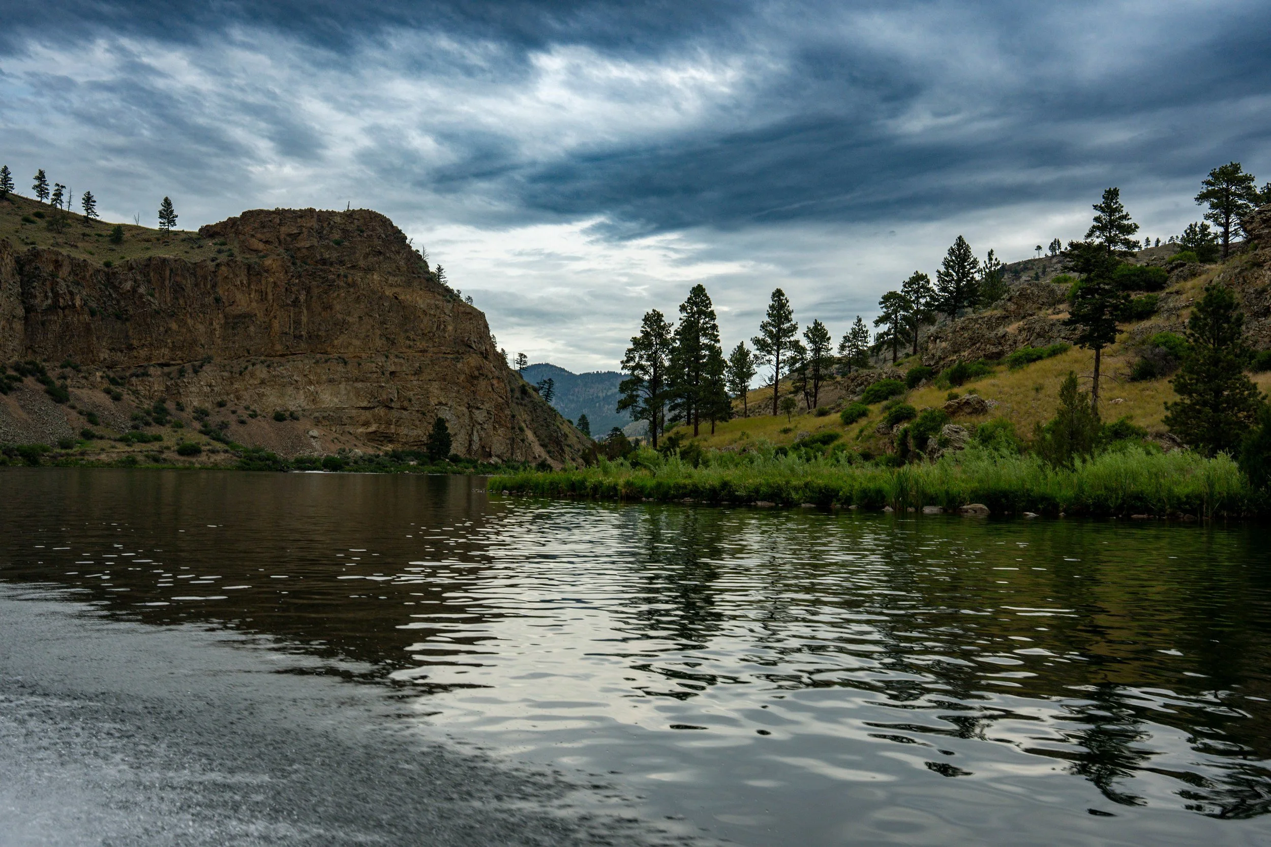 Rocky bluff and pines by the water, Montana