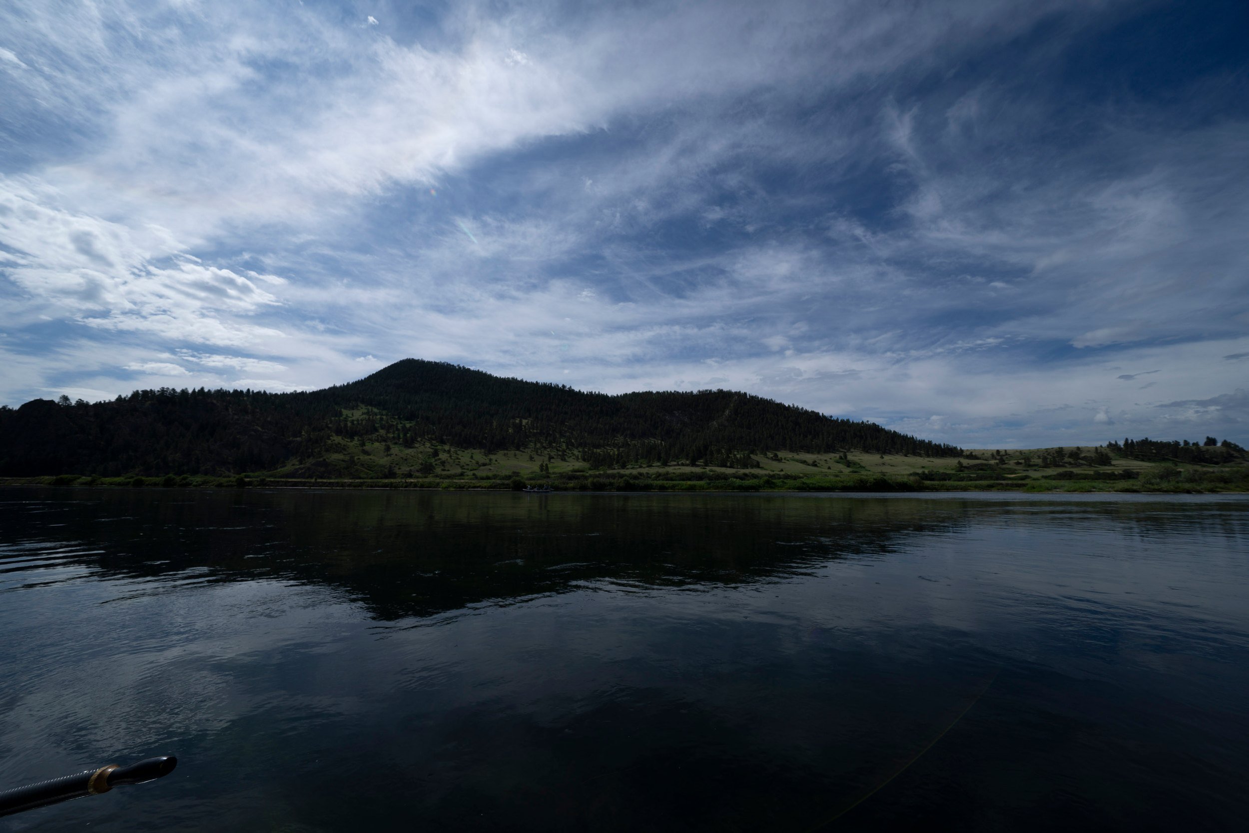 Low sun under storm clouds on the river, Montana