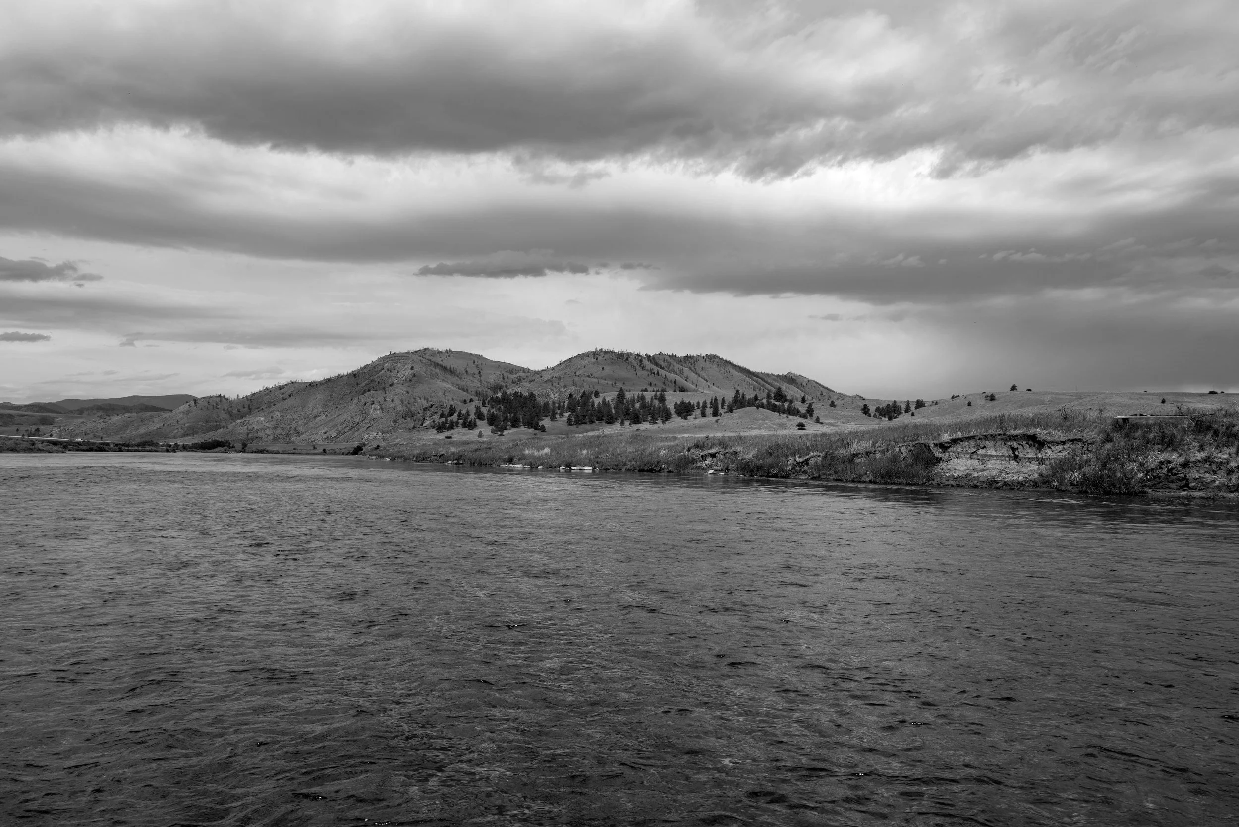 River and distant buttes, black and white, Montana