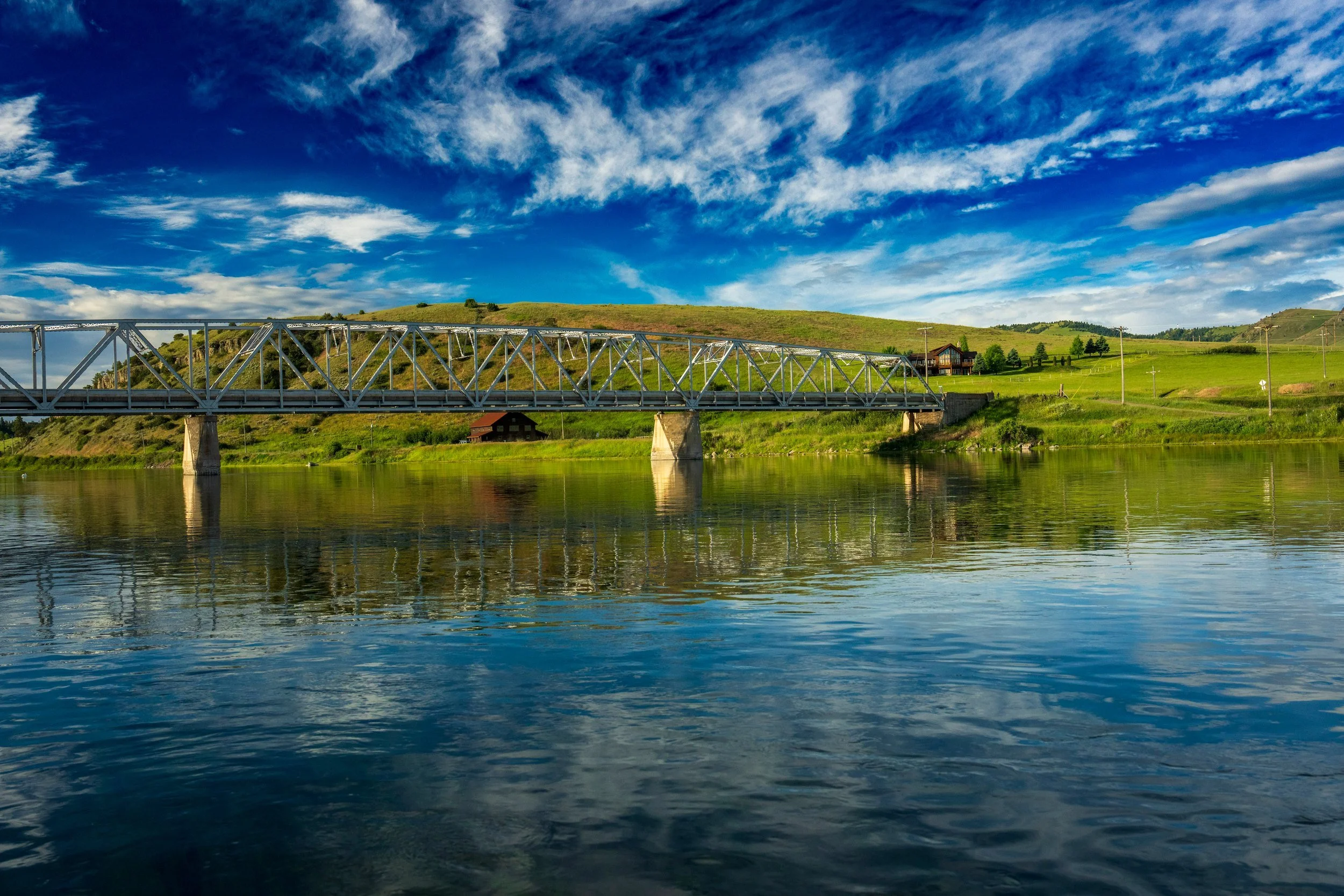 Old bridge across a calm river, Montana