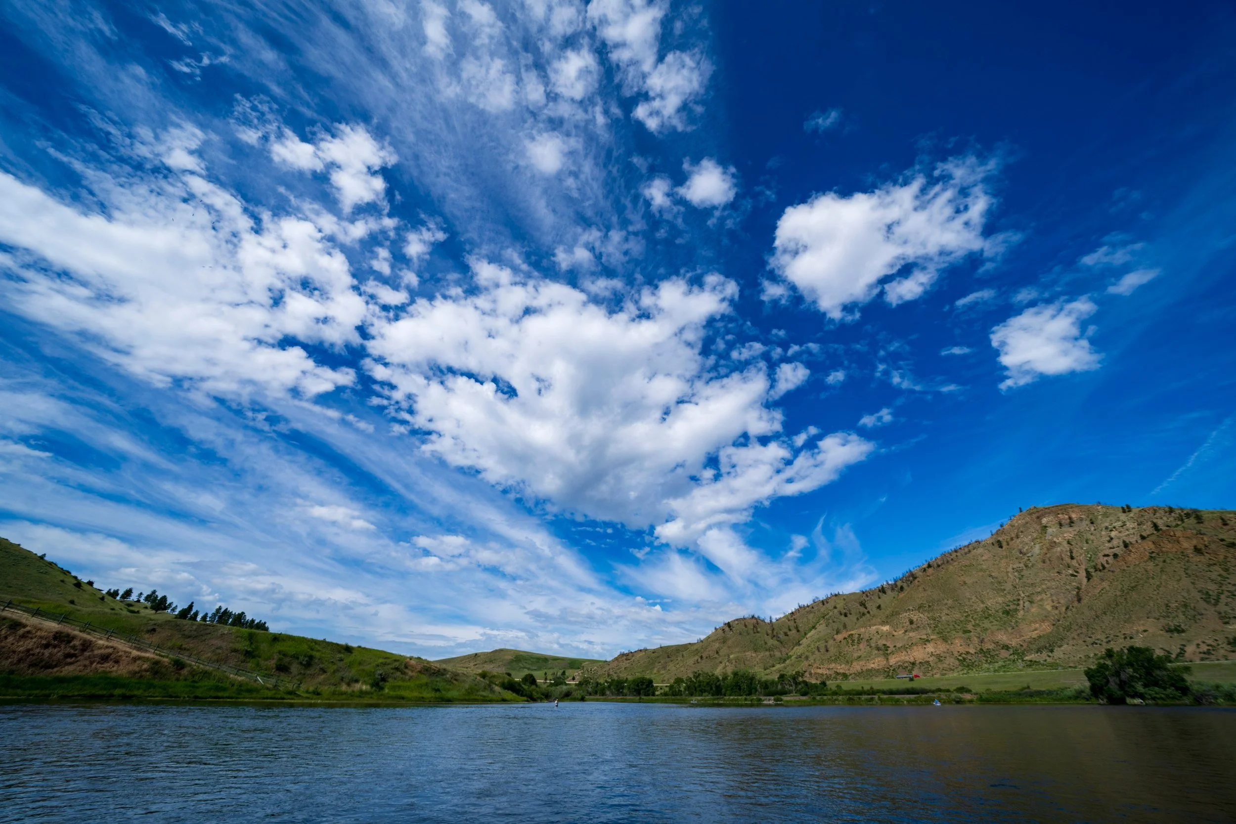Streaming clouds over a mountain river, Montana