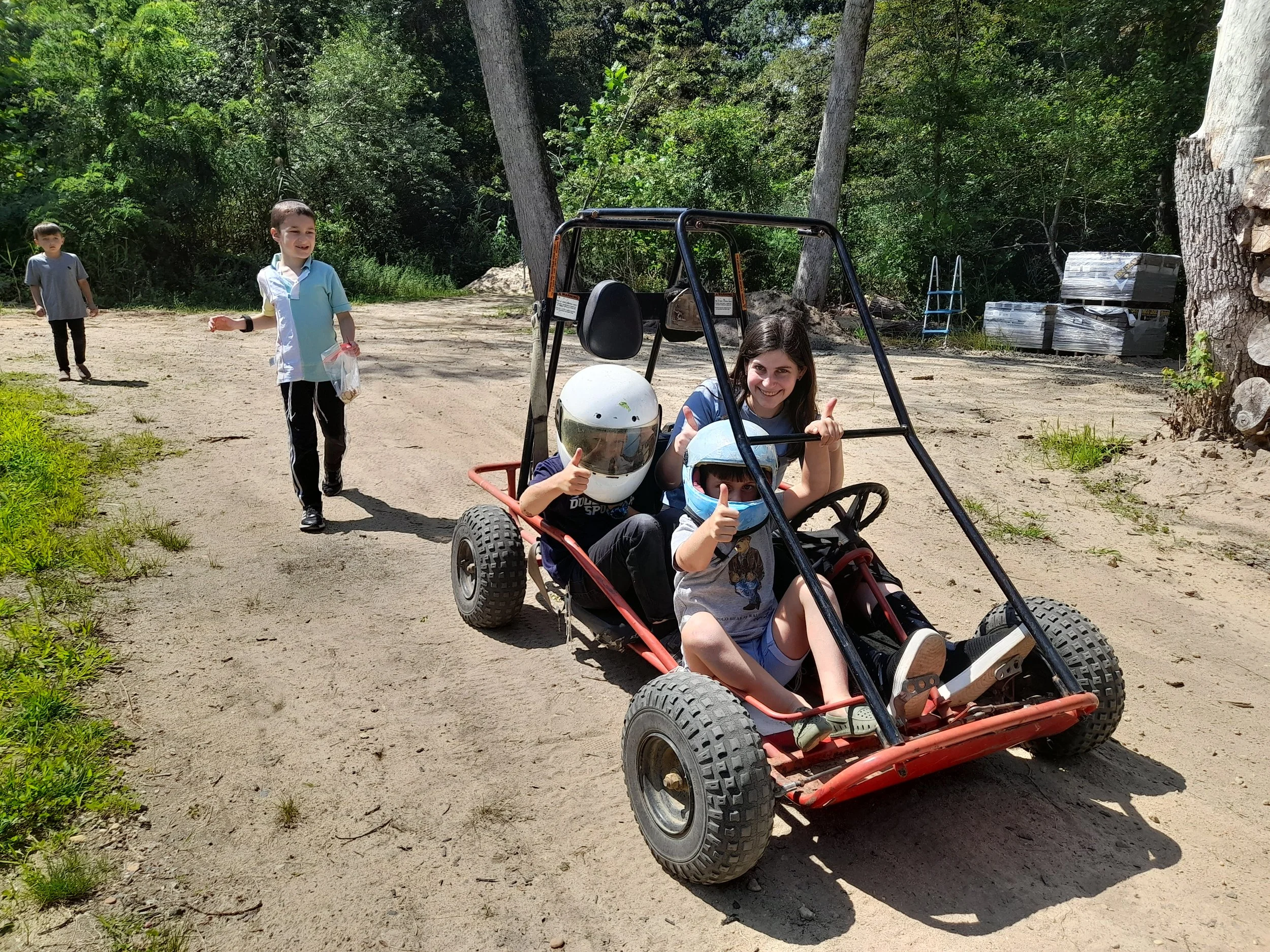 Children riding a go-kart outdoors