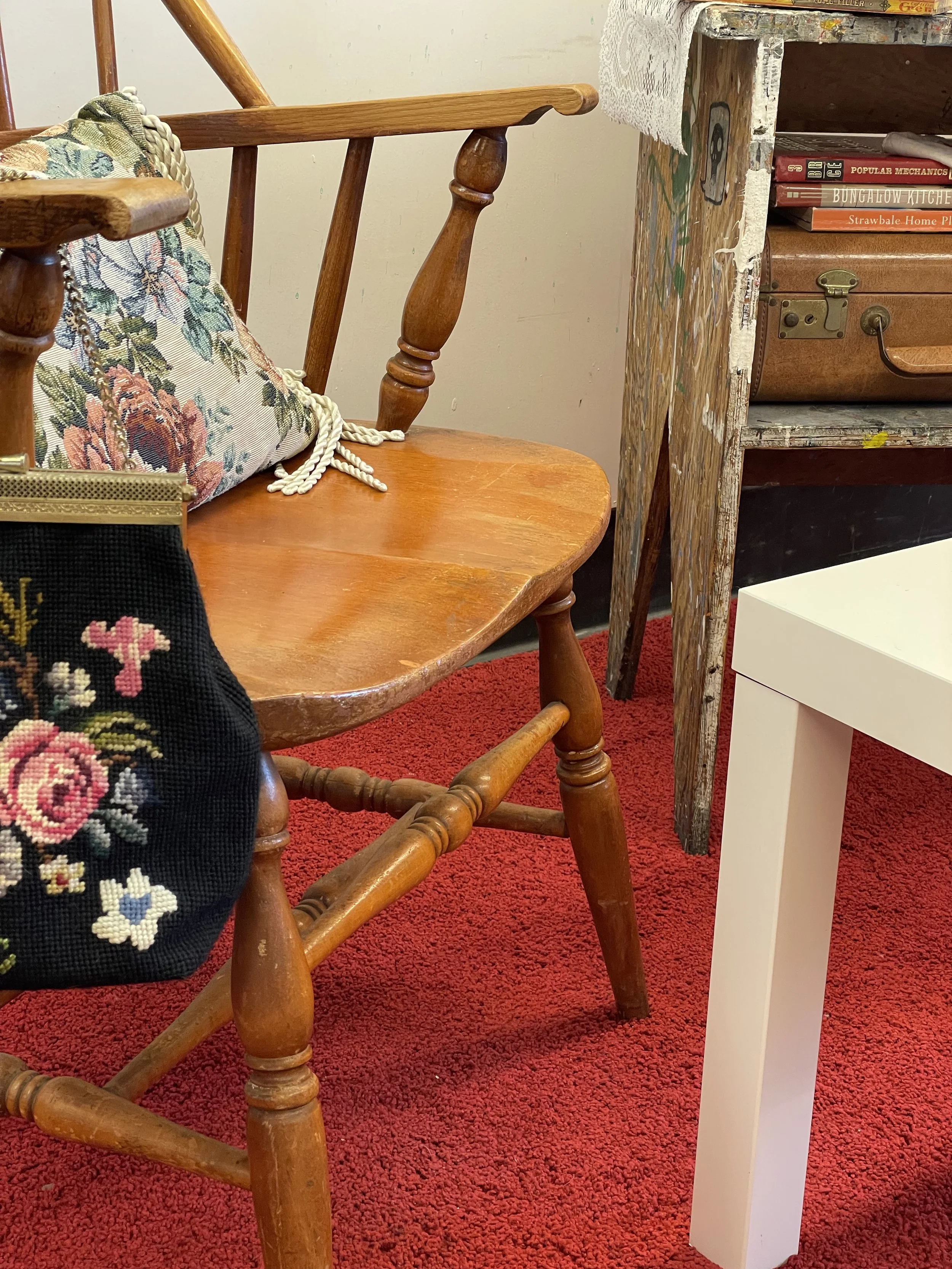 To Sell A Home, 2025, installation details - needlepoint purse, floral cushion, and suitcase from the Home