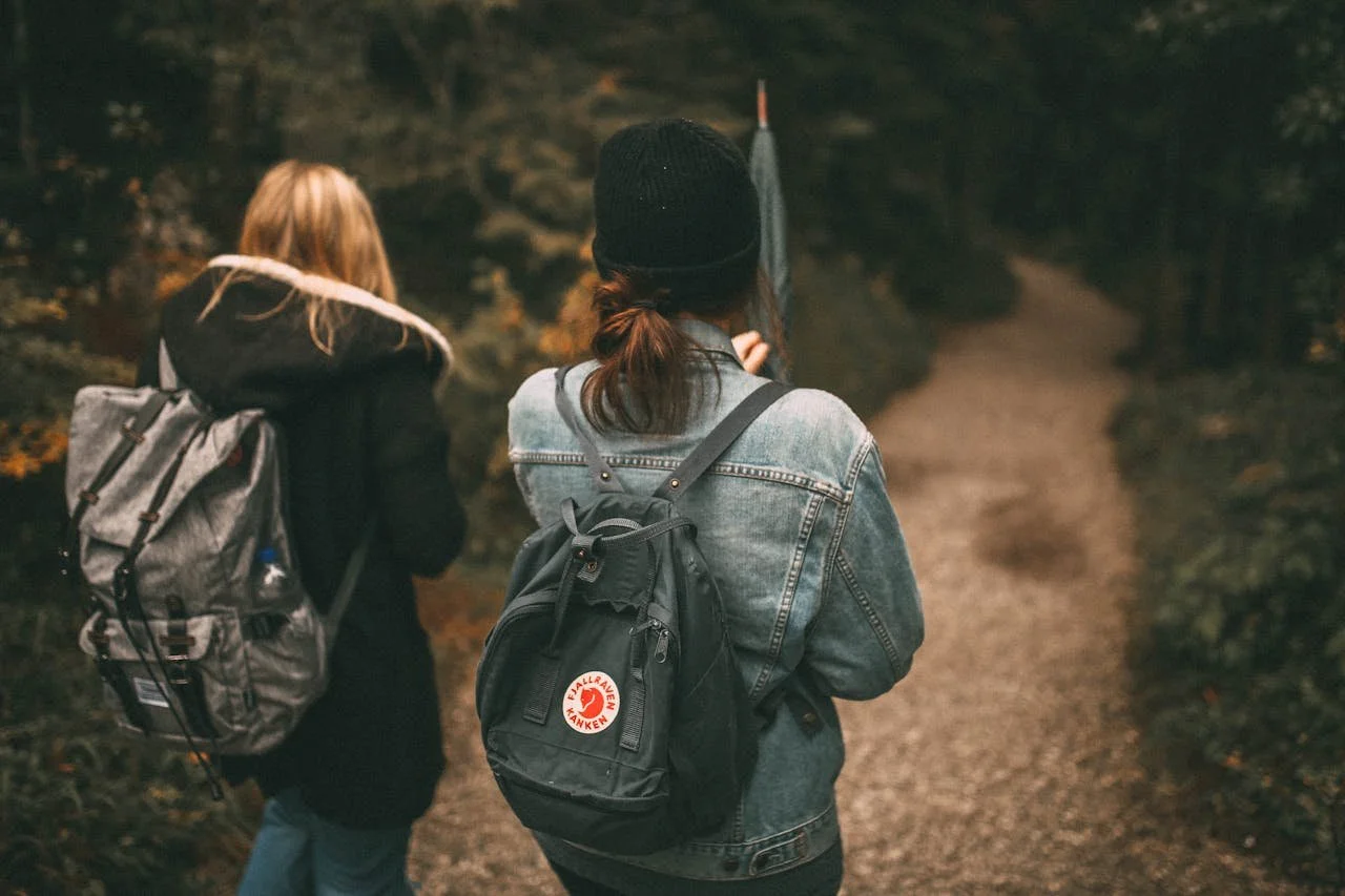 Two women walking together on a trail during a life transition