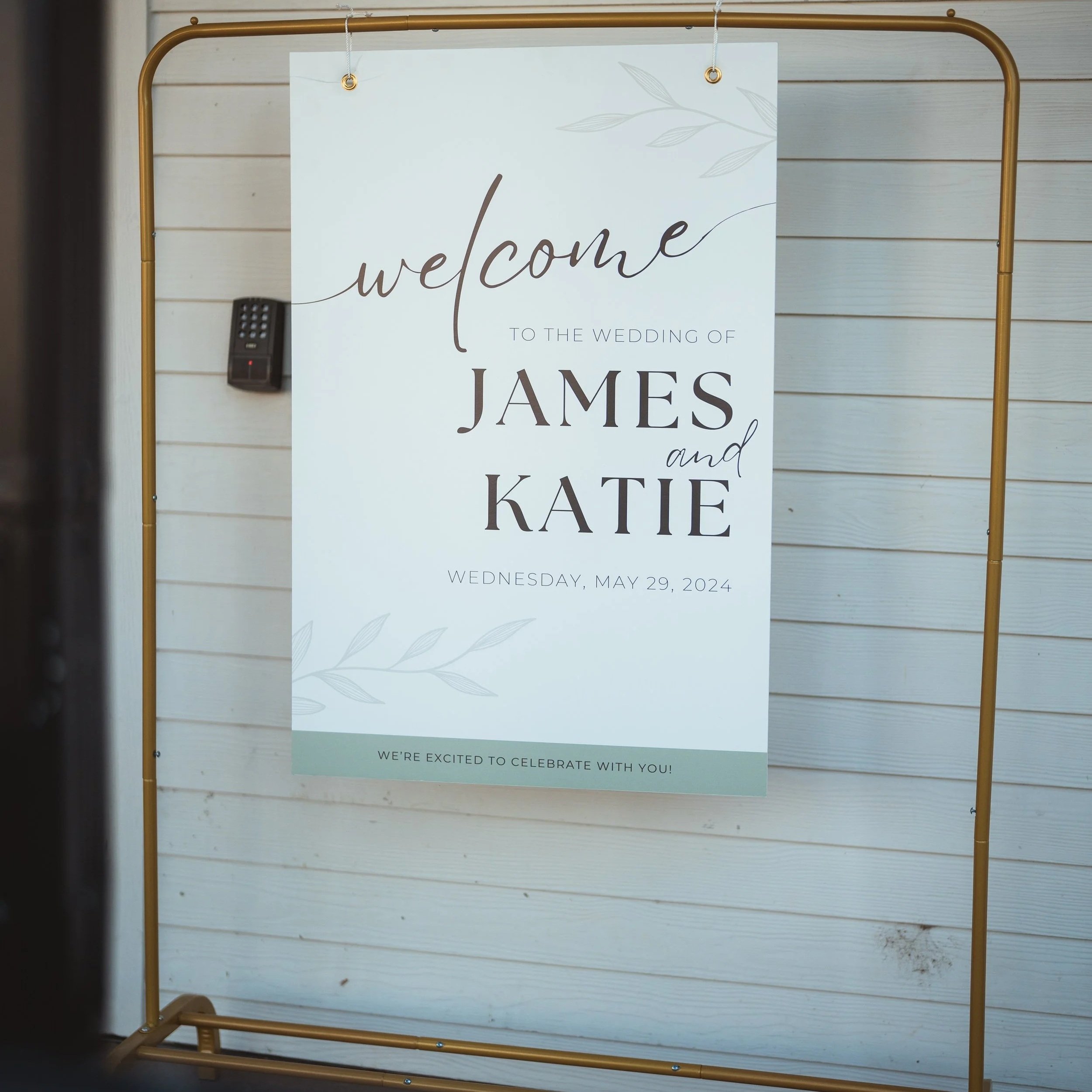 A gold metal wedding sign structure holds the wedding welcome sign of a couple whose wedding was planned by JayBird Weddings and Events