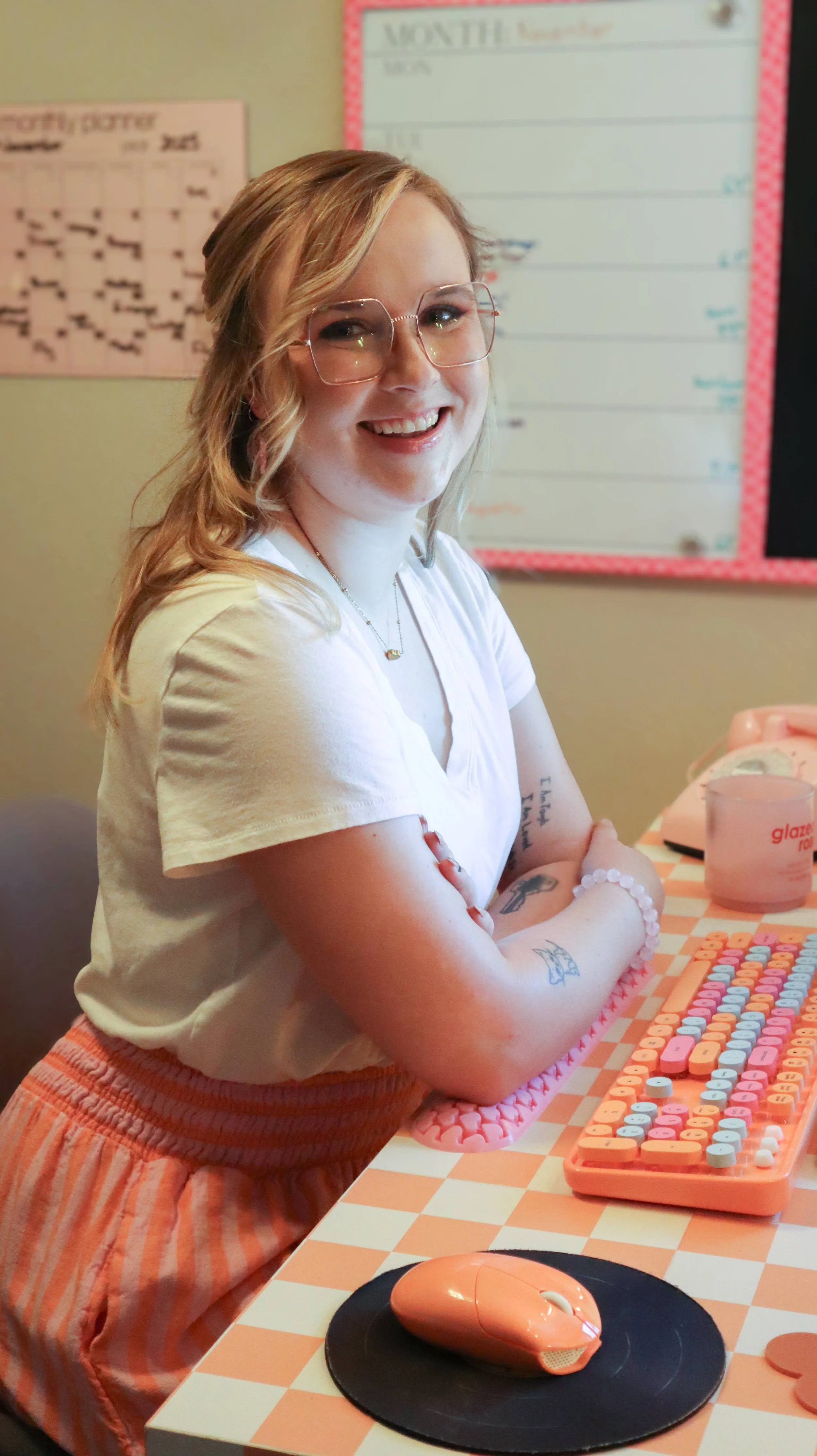 Moriah, the owner of JayBird Weddings and Events, poses at her desk