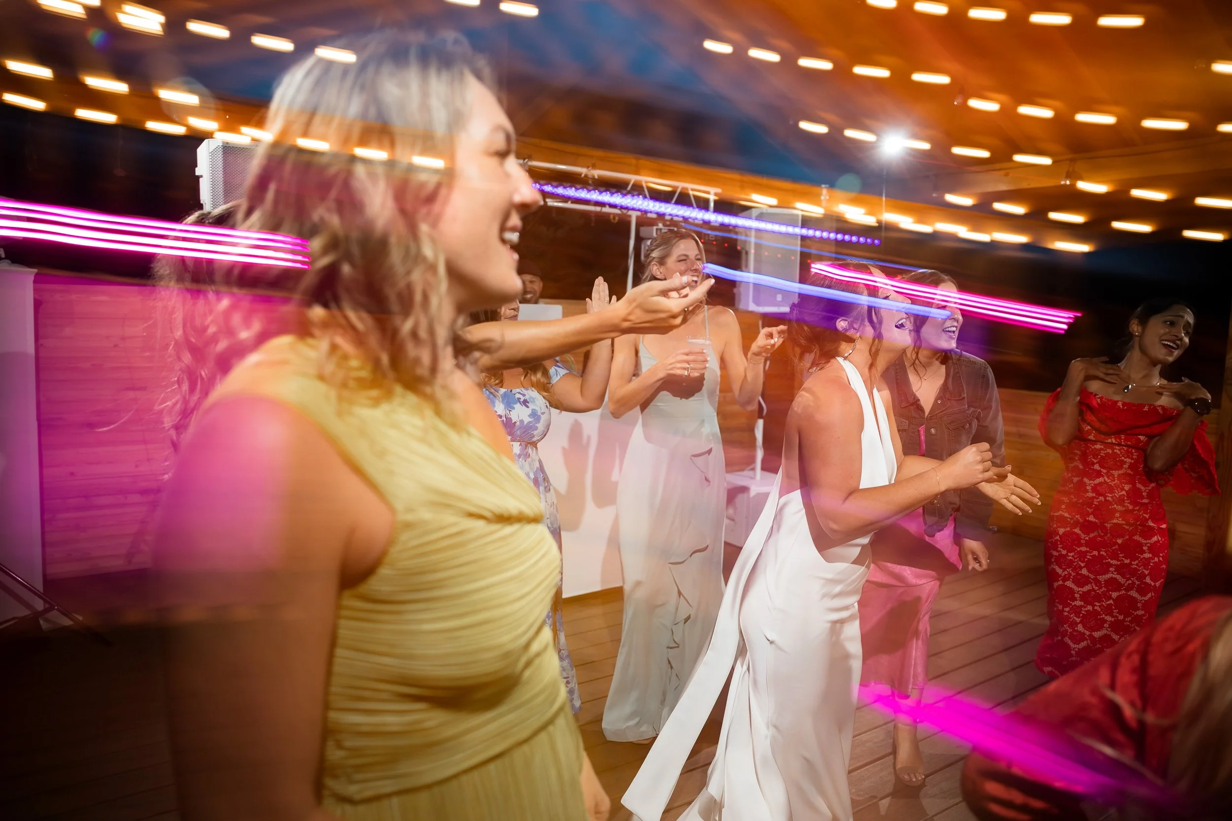 A bride and her bridesmaids dance at her wedding in Salida, Colorado, planned by JayBird Weddings and Events