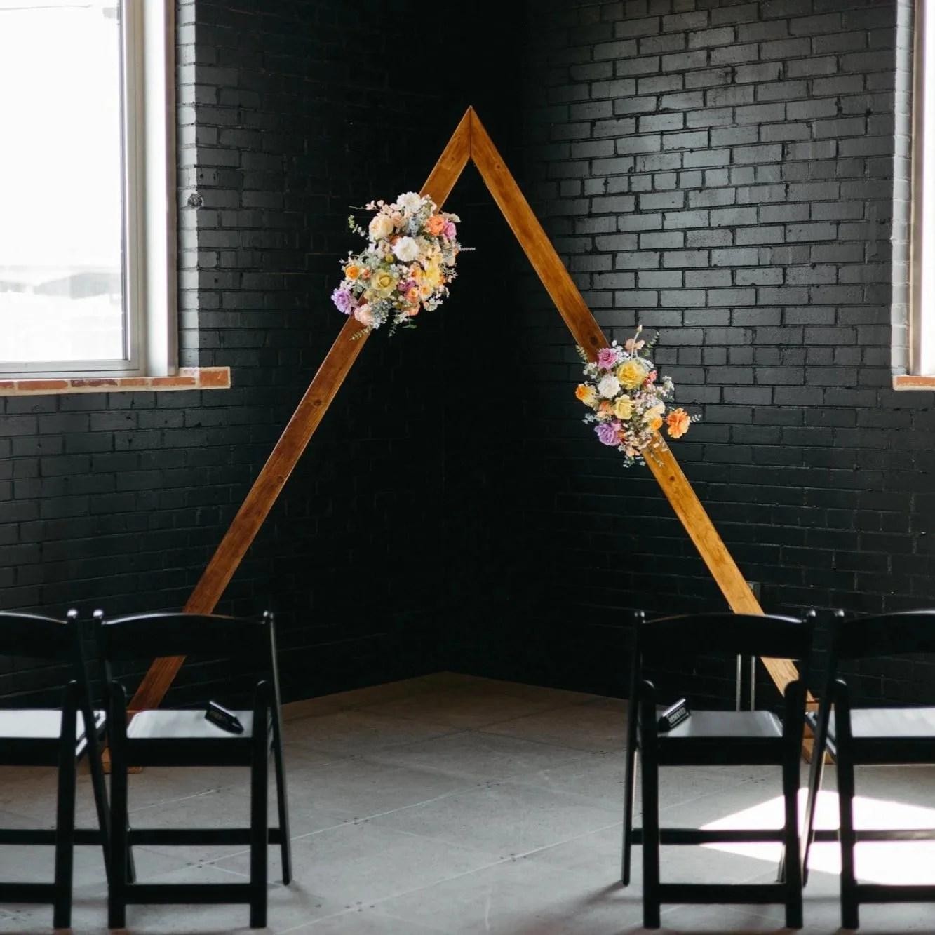 A wooden triangle arch available to couples whose Colorado wedding planner is JayBird Weddings and Events