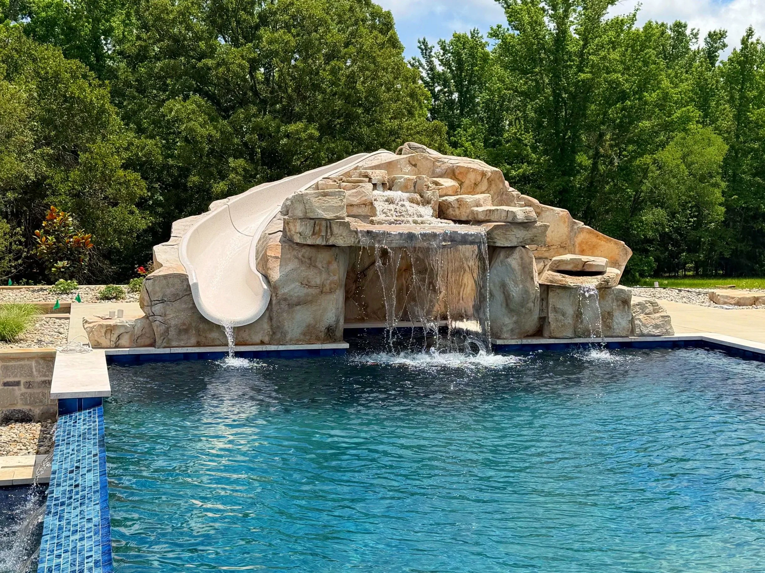 Completed artificial rock waterfall grotto with waterslide