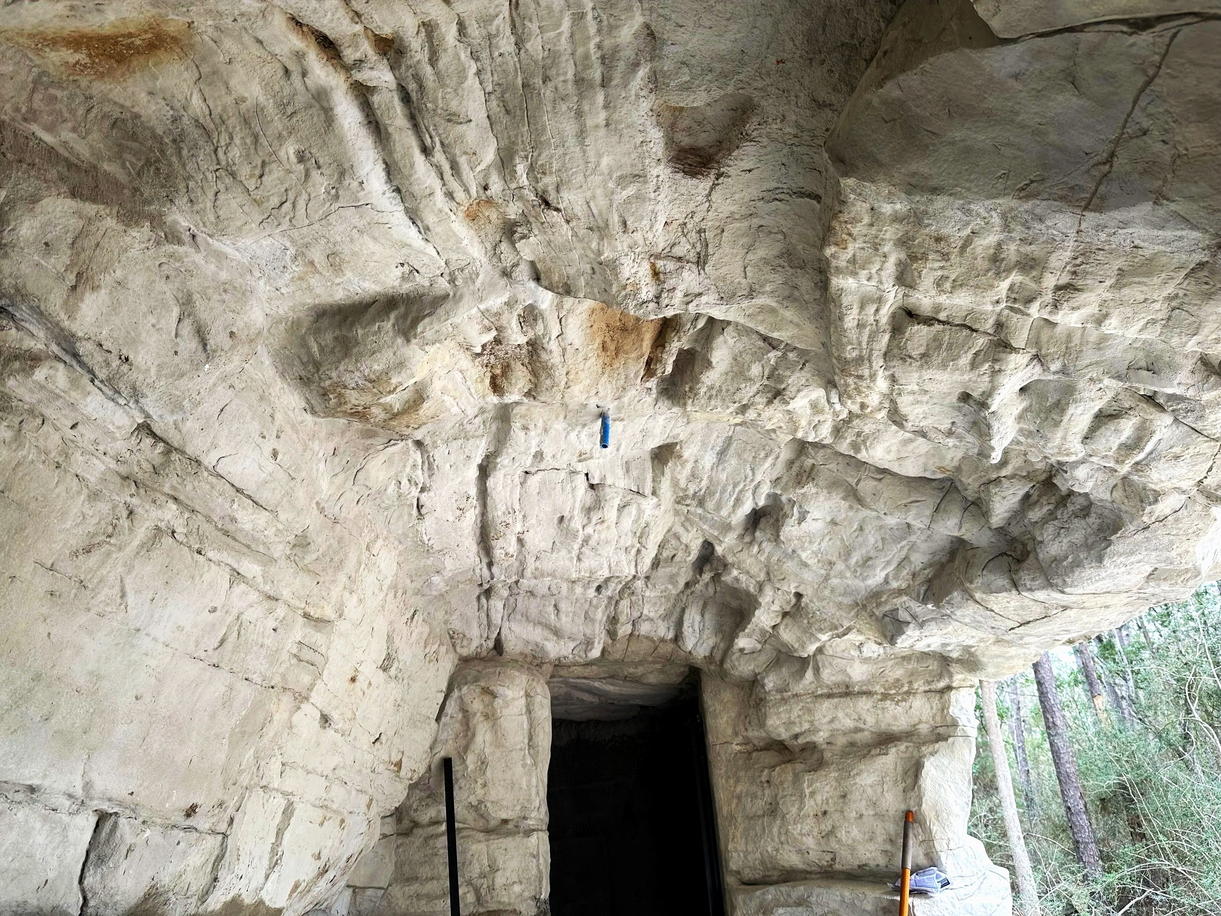 Interior of naturalized artificial rock cave at an outdoor venue.