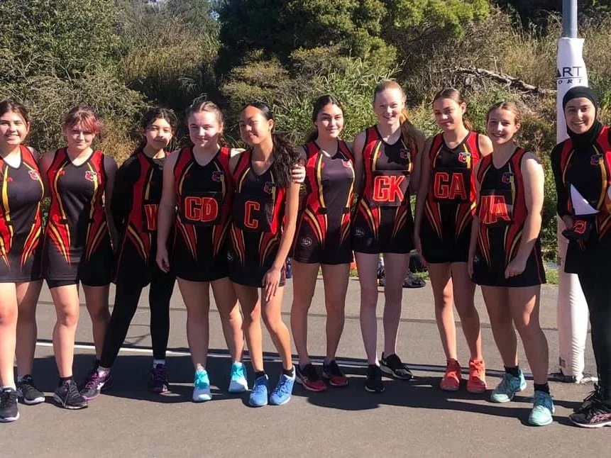Group of young women in sports uniforms outdoors
