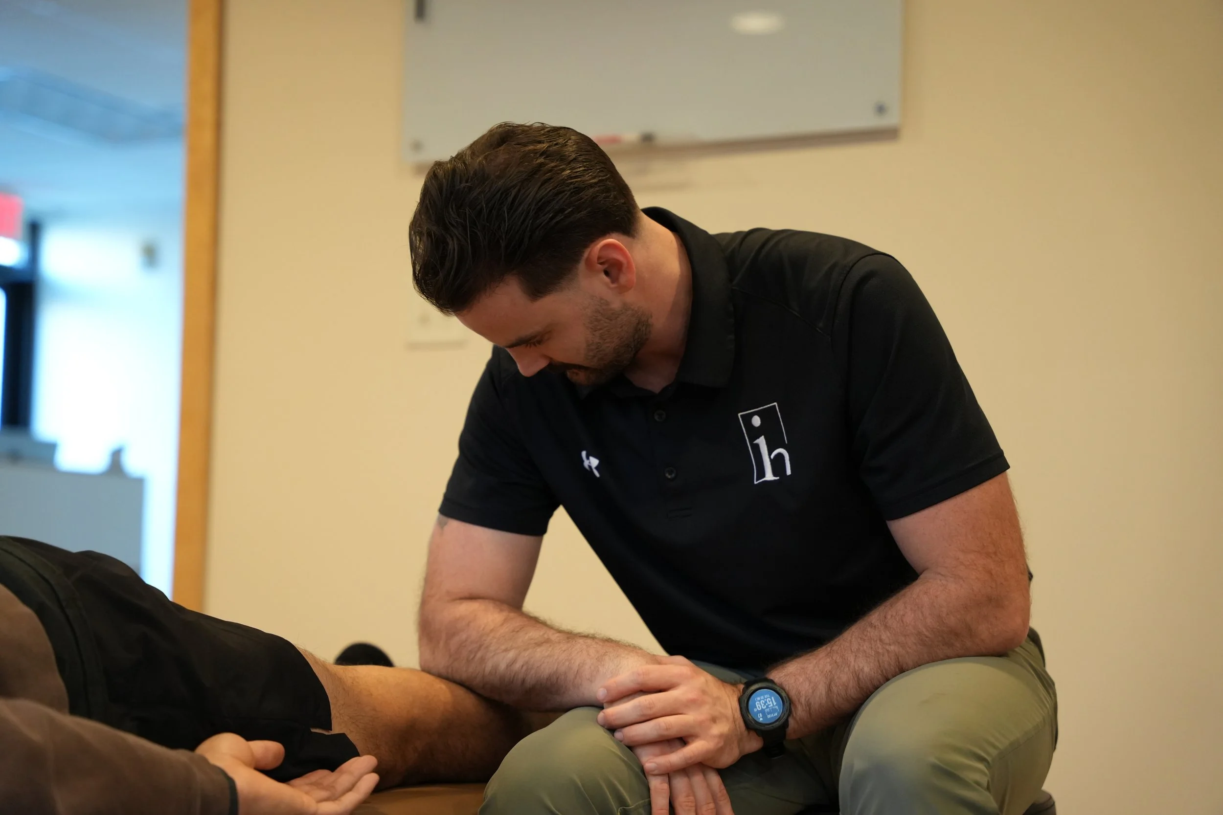 A person receives a vaccination or injection in their upper arm from a healthcare professional.