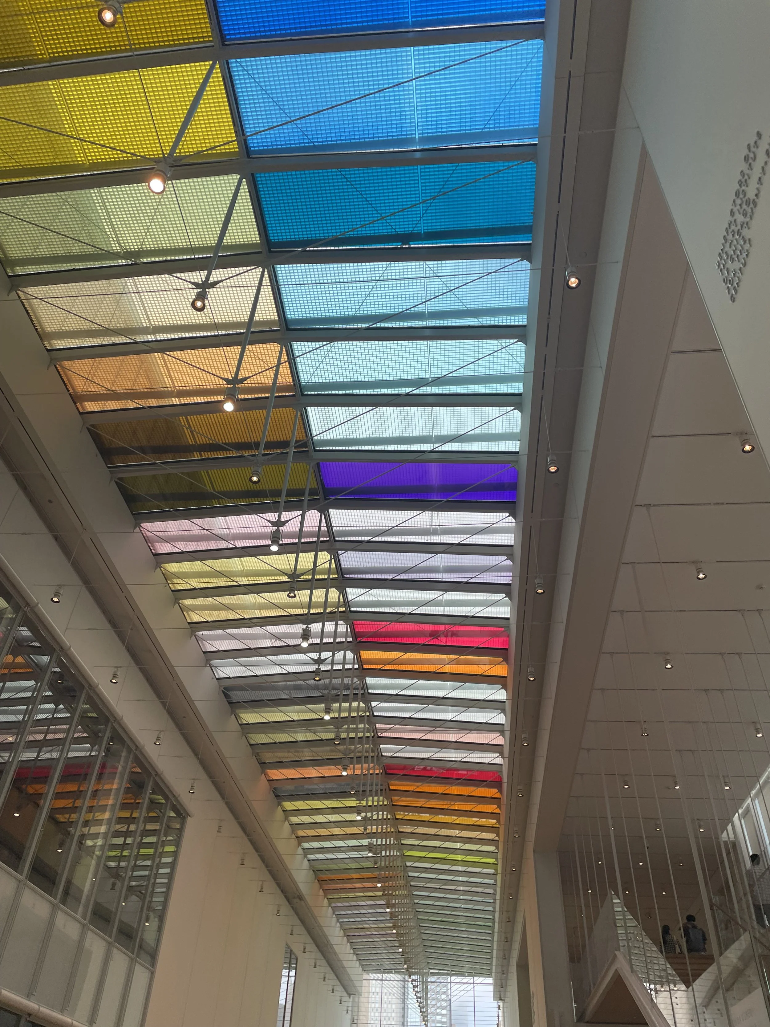 Glass ceiling with rainbow colored panels of glass.