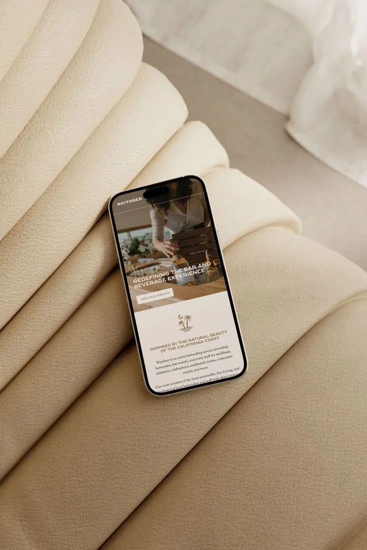 Smartphone displaying a bar and beverage service ad, placed on a beige leather seat.