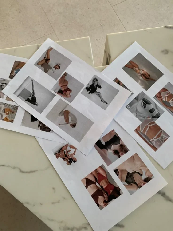 Photographs of people wearing various outfits arranged on a marble table.