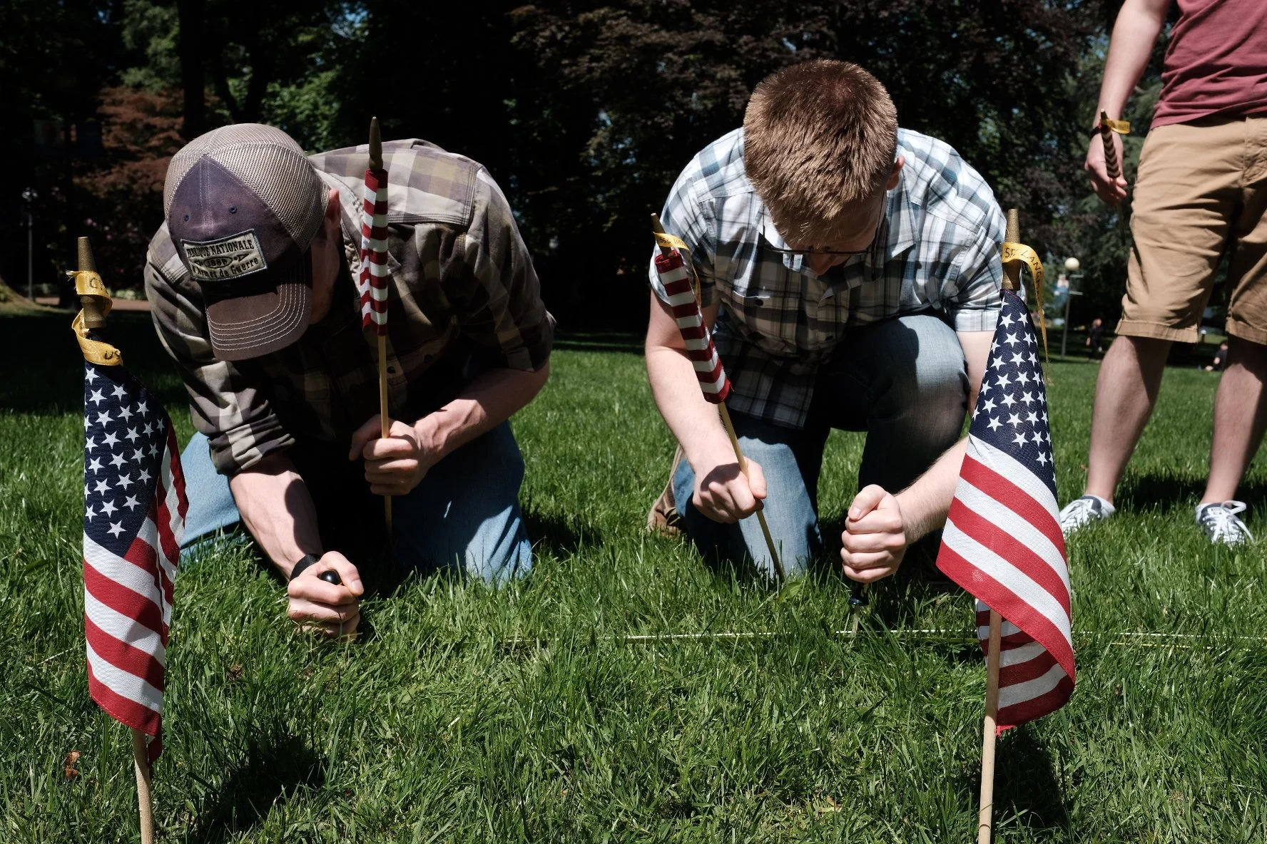 veterans placing flags on Memorial Day