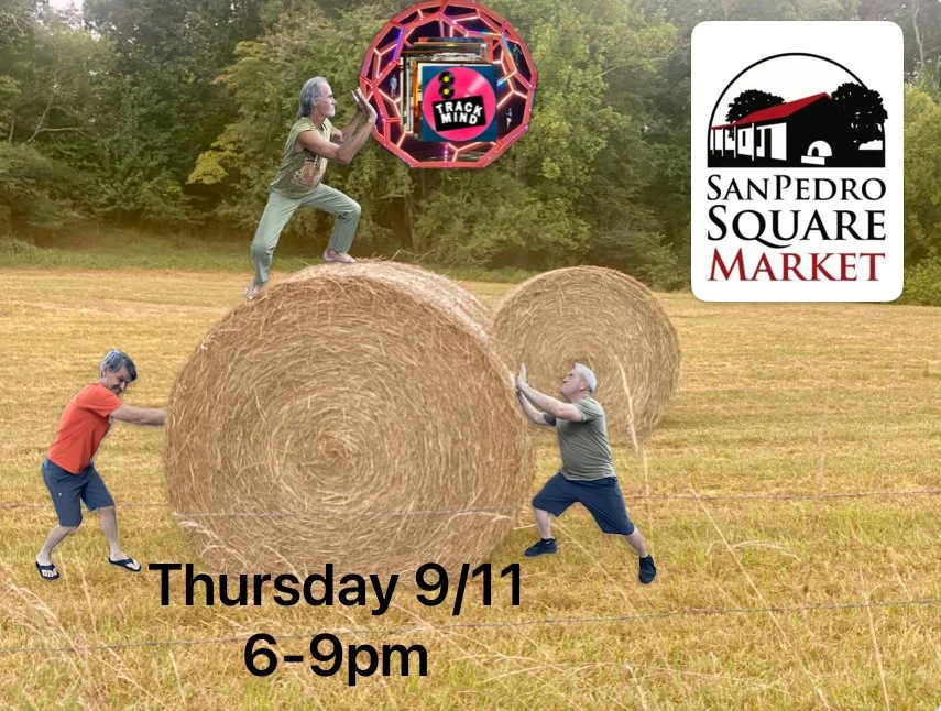 Three people in a field with hay bales, one person is balancing on a bale, two are pulling on ropes attached to the bales, and there is a large neon sign that says '8 Track Mind' in a geometric frame. In the top right corner, there's a logo for San P