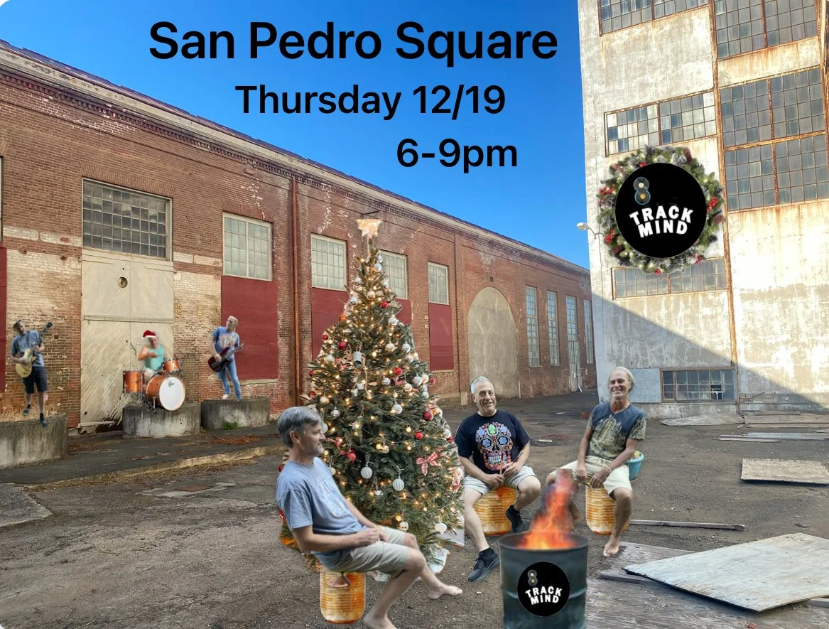 A digitally edited scene with four men sitting around a Christmas tree on an industrial lot, with a band performing on a raised platform in the background, and a sign for Track Mind event at San Pedro Square on December 19 from 6 to 9 pm.