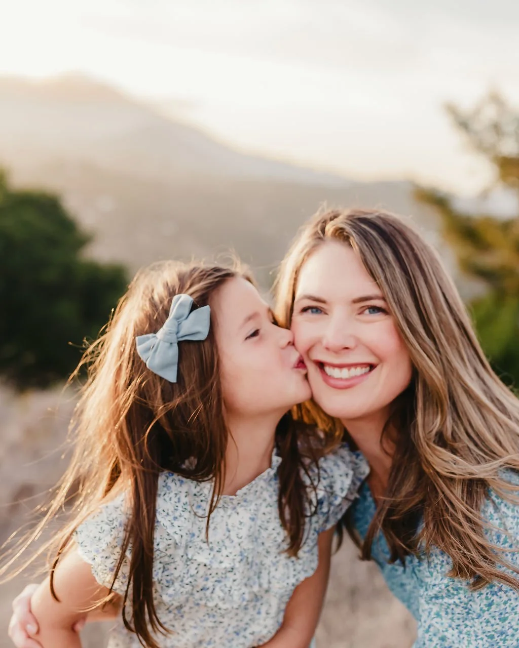 daughter-kissing-mother-s-cheek-candid-family-portraits.jpg