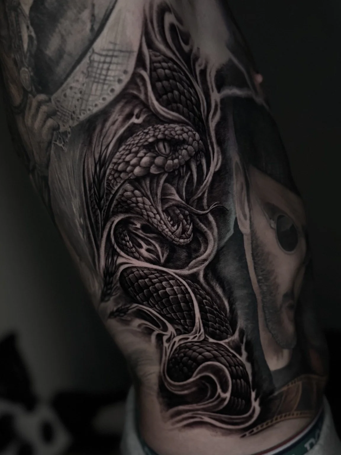 Black and grey realistic snake tattoo by Alina Horobets, Bournemouth