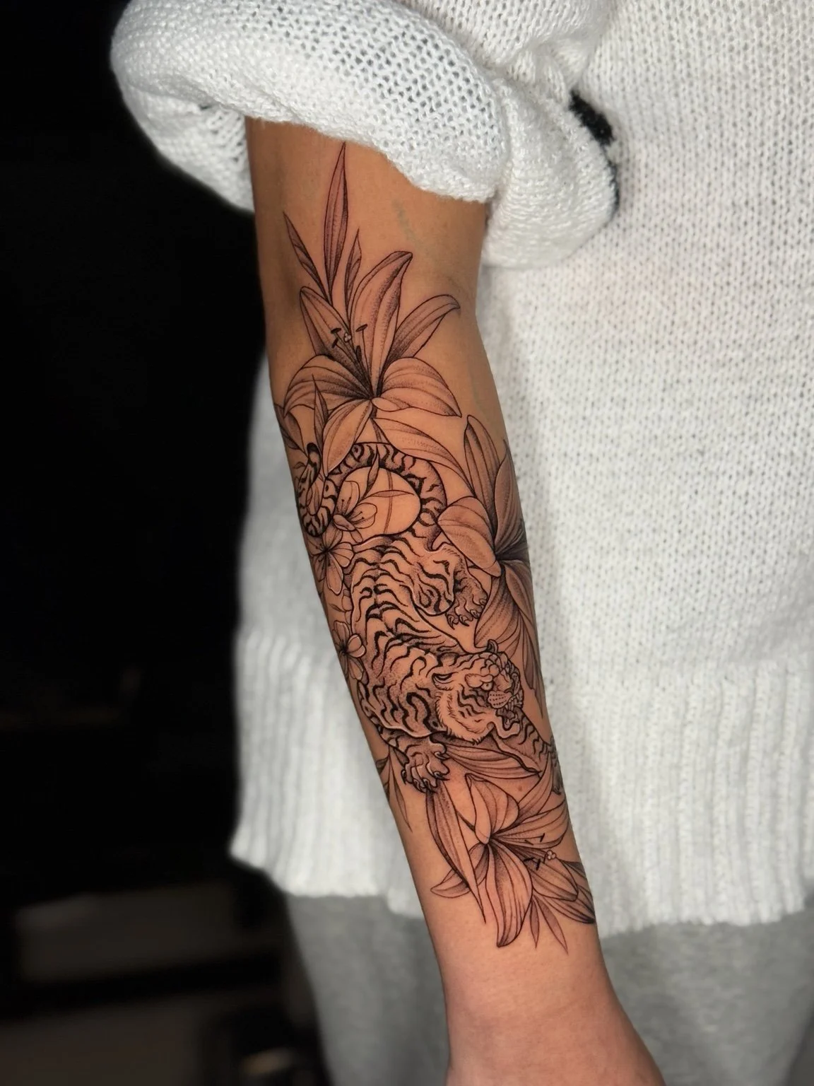 Fine line floral forearm tattoo by Alina Horobets, Bournemouth