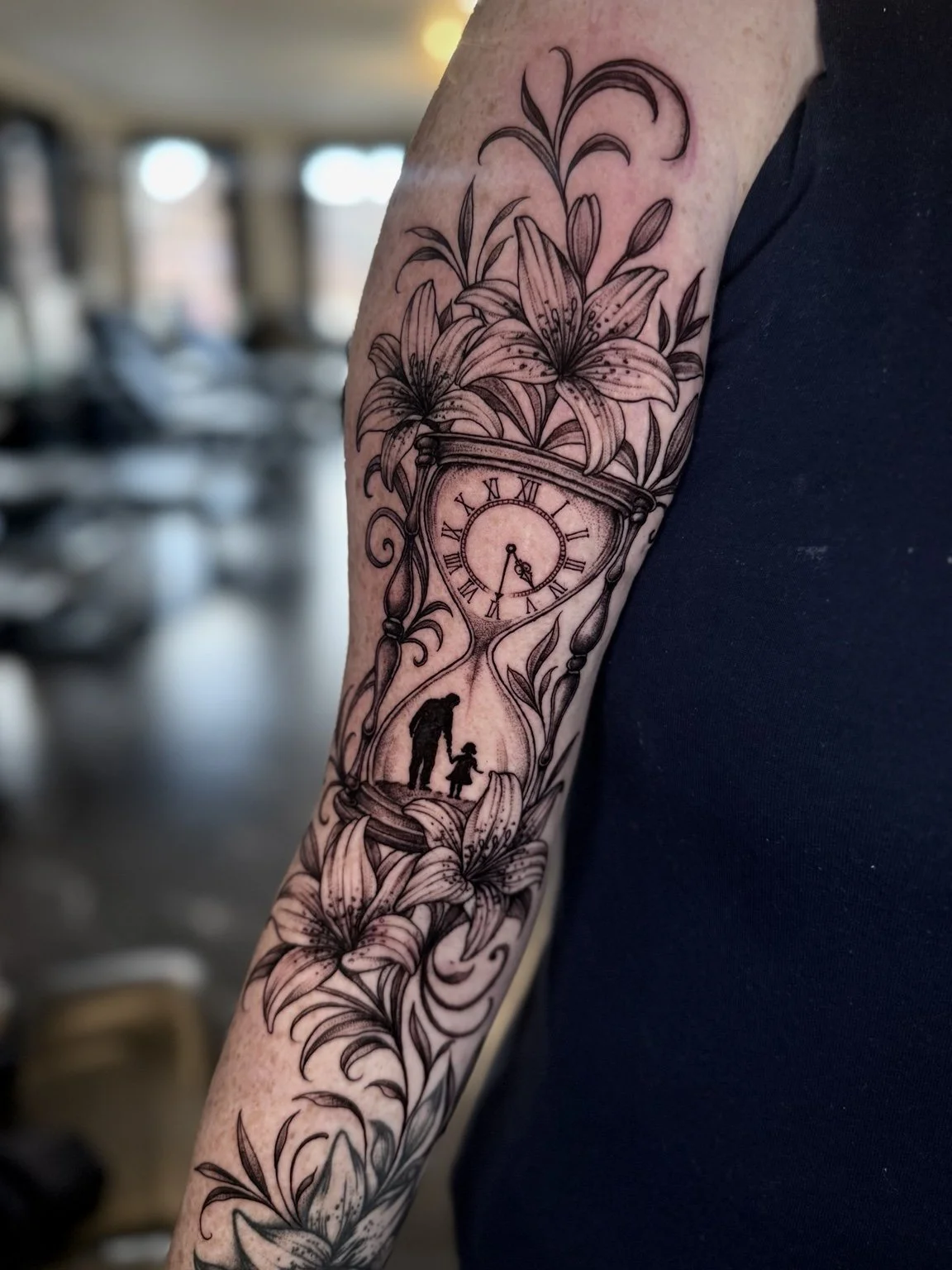 Floral clock and silhouette forearm tattoo by Alina Horobets, Bournemouth