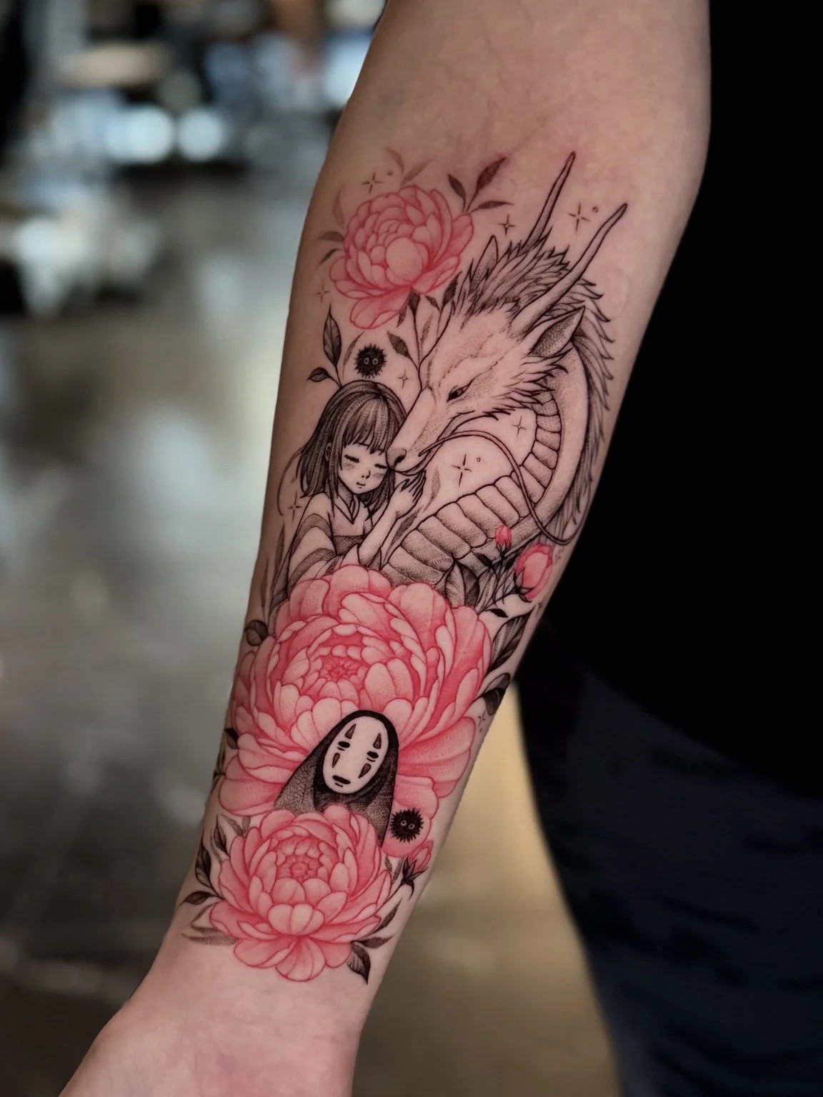 Studio Ghibli character forearm tattoo with red peonies by Alina Horobets, Bournemouth