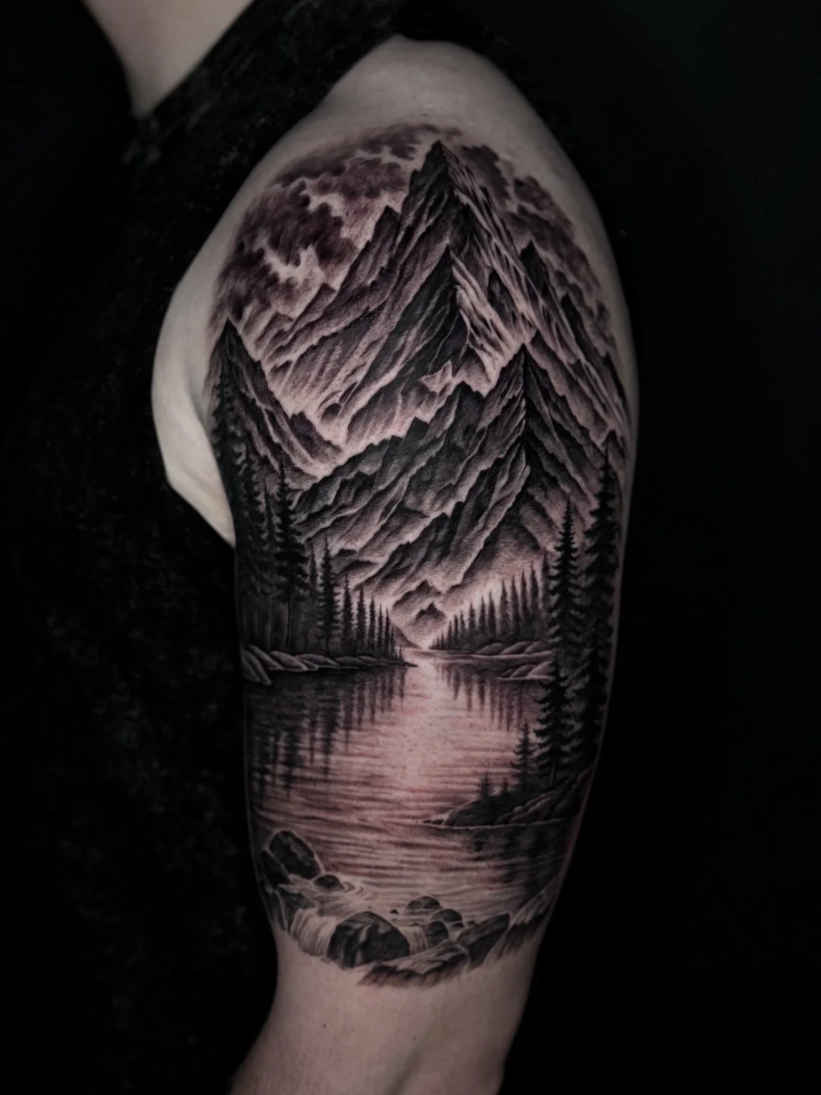 Black and grey mountain and lake landscape tattoo by Alina Horobets, Bournemouth