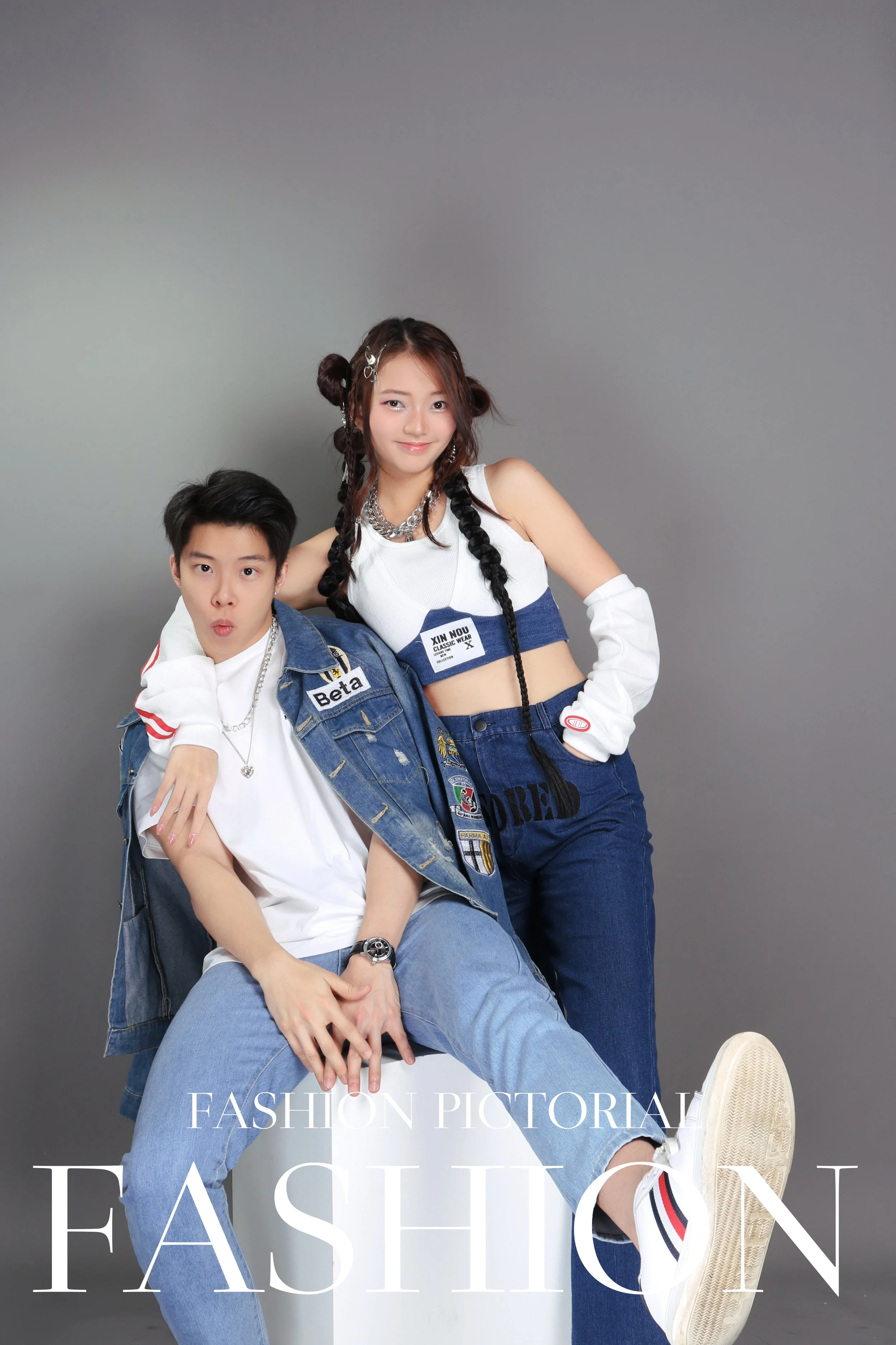 Couple in American street style denim outfit posing fun and cool in studio