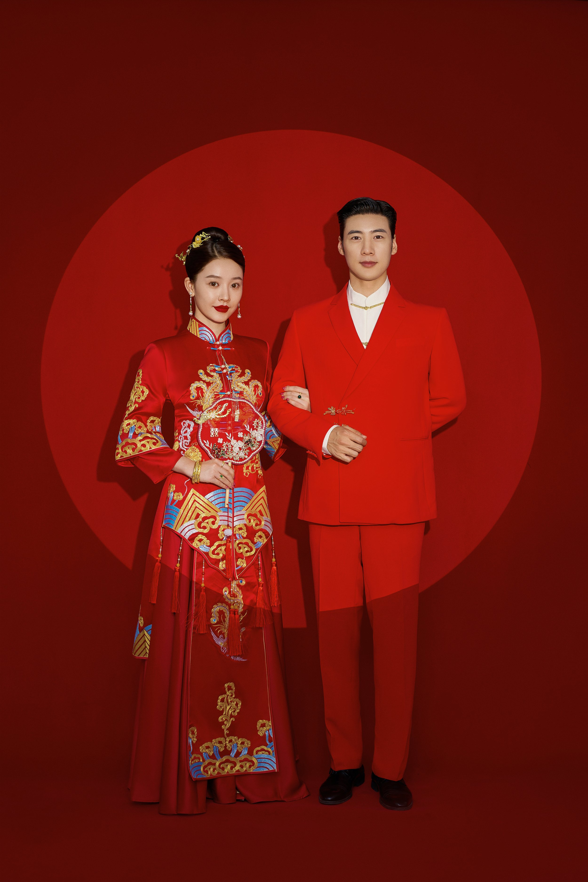 Traditional Chinese pre-wedding indoor photoshoot with a young Asian couple in red suit and traditional wedding dress