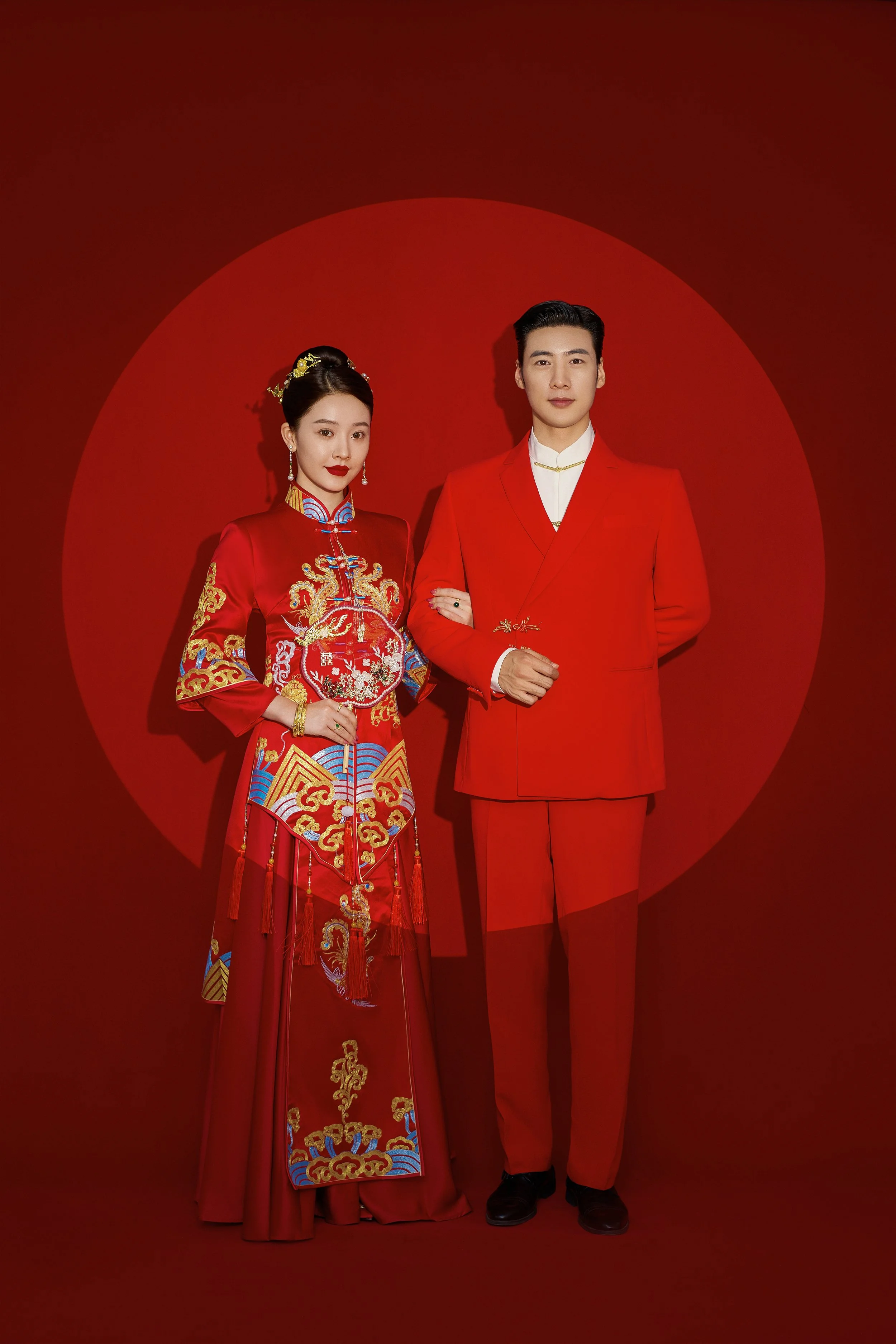 Traditional Chinese pre-wedding indoor photoshoot with a young Asian couple in red suit and traditional wedding dress