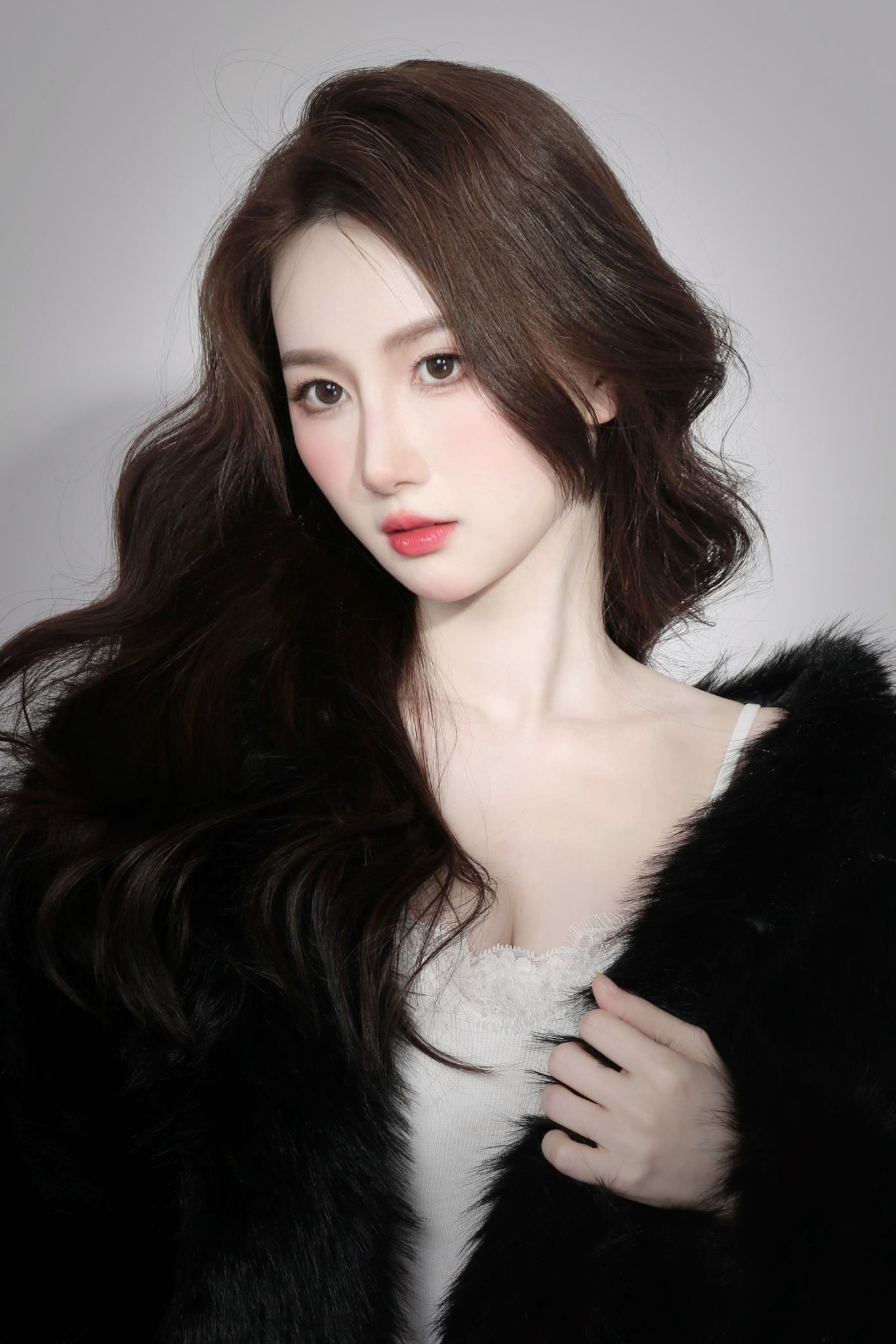 Moody aesthetic portrait of a woman with contrast lighting and feminine makeup