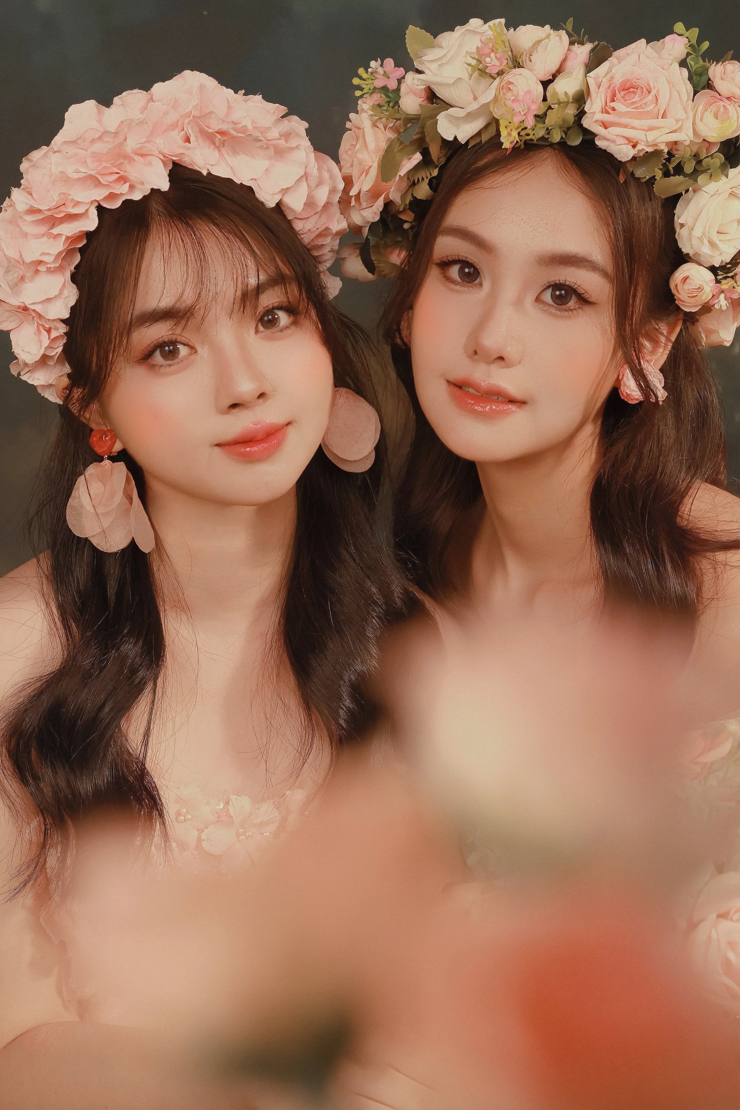 Two females in pink rose flower crowns posing at the camera