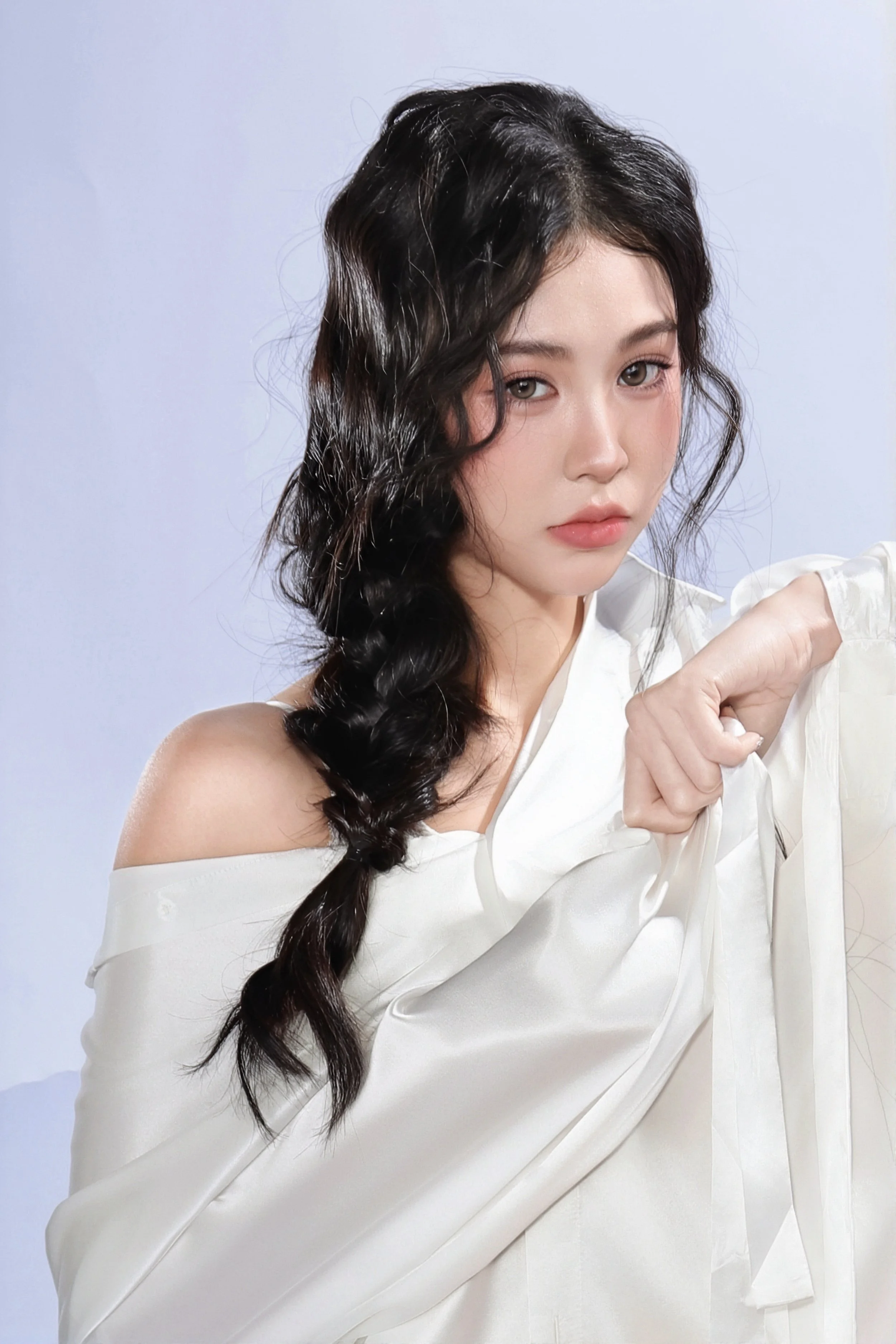 Minimalist portrait of a woman with natural makeup and clean studio background